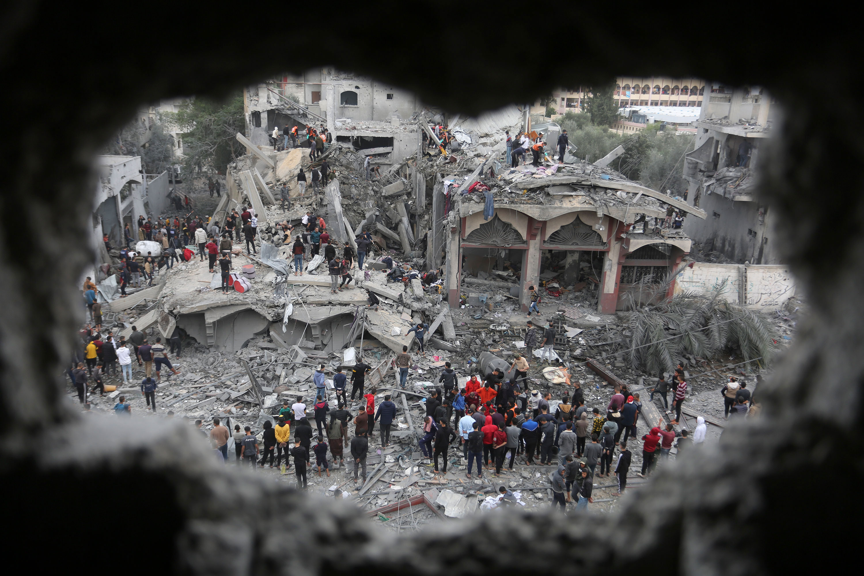 Palestinians search for survivors after an Israeli strike in Rafah, Gaza, on November 22. 