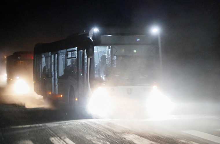 Buses carrying service members of Ukrainian forces from the besieged Azovstal steel mill drive away under escort of the pro-Russian military in the course of Ukraine-Russia conflict in Mariupol, Ukraine, Monday, May 16.