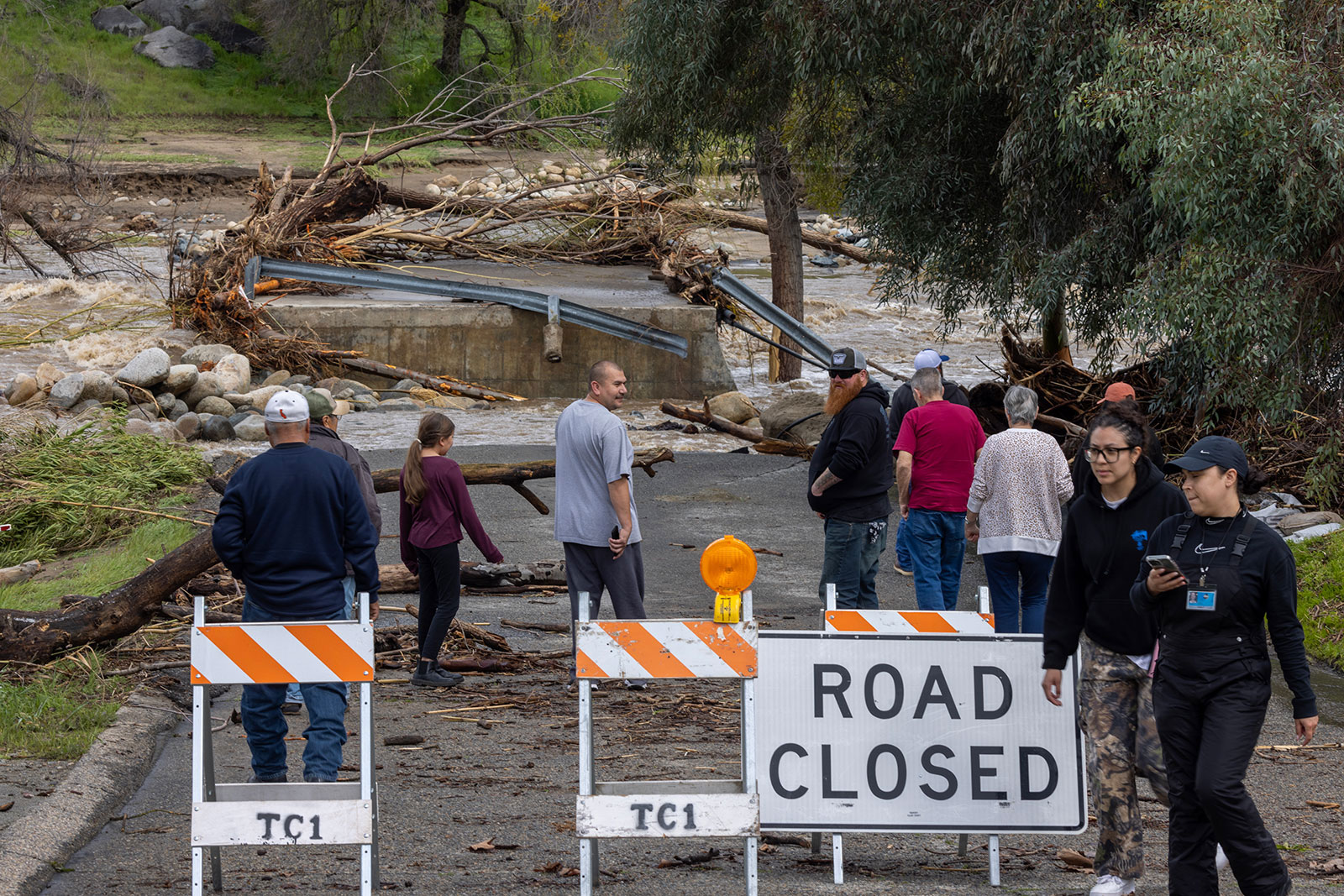 People view the wreckage of a bridge over the Tule River that was destroyed in a flash flood on March 10 in Springville, California.