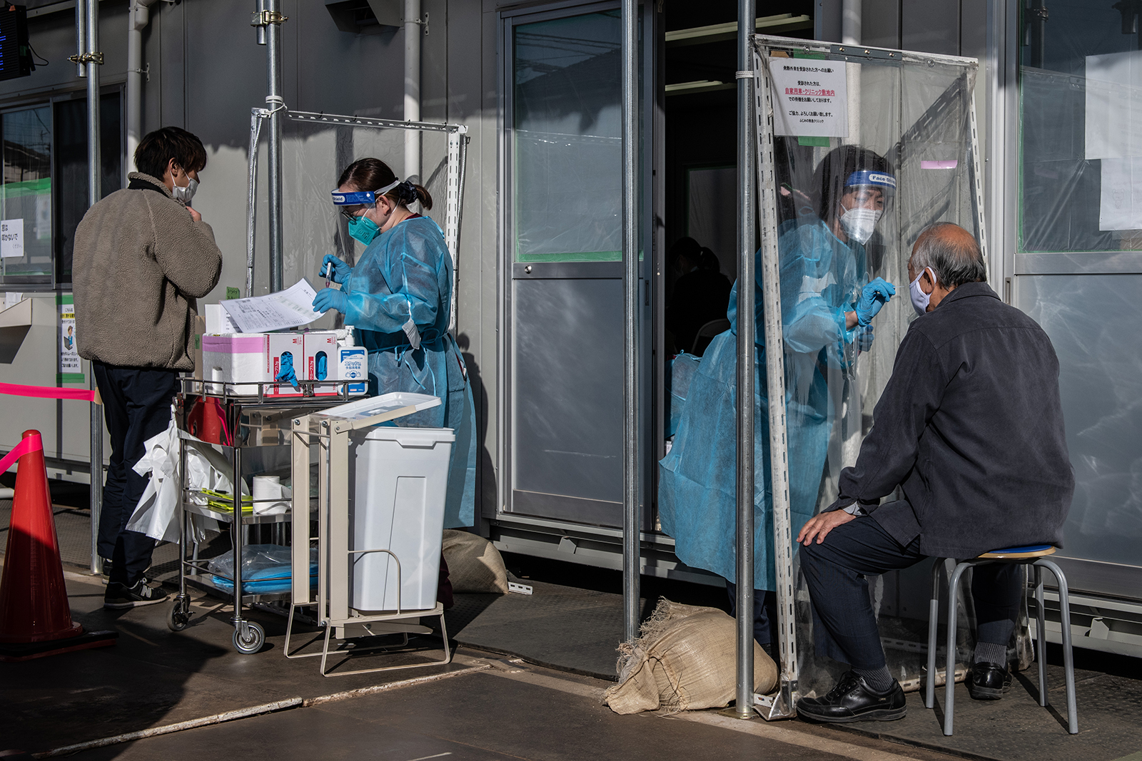A nurse collects a nasal swab sample at a Covid-19 testing center at Fujimino Emergency Hospital in Miyoshi-machi, Japan, on December 18.