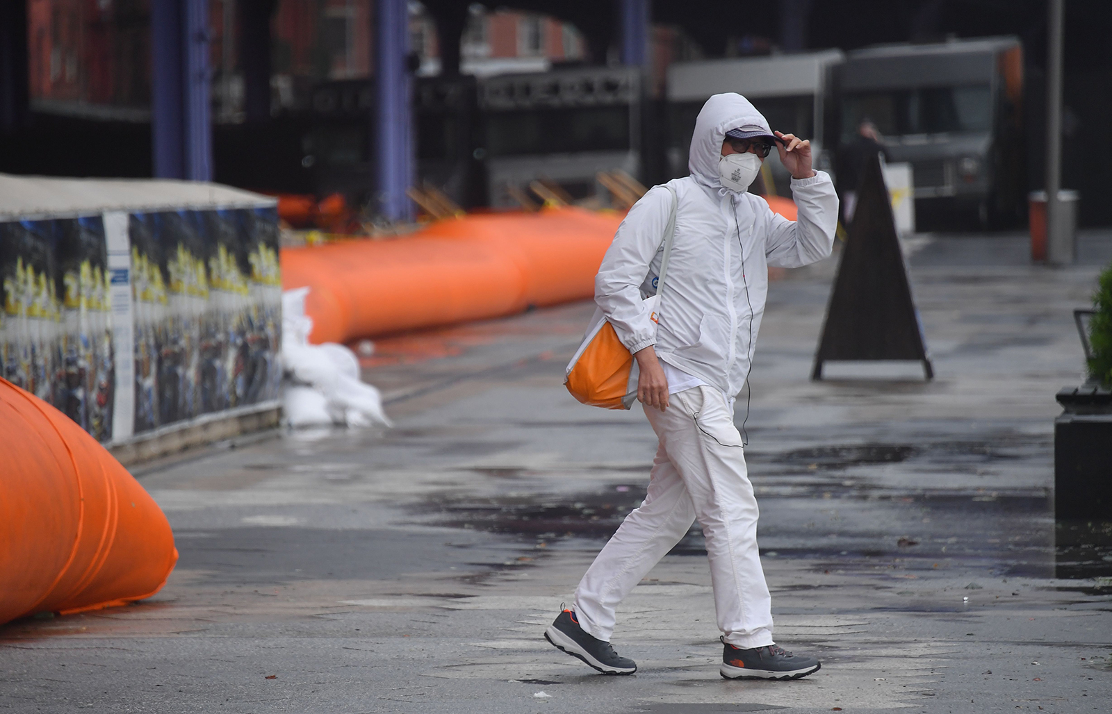 A person walks past flood barriers in lower Manhattan as Tropical Storm Isaias approaches New York City on August 4.