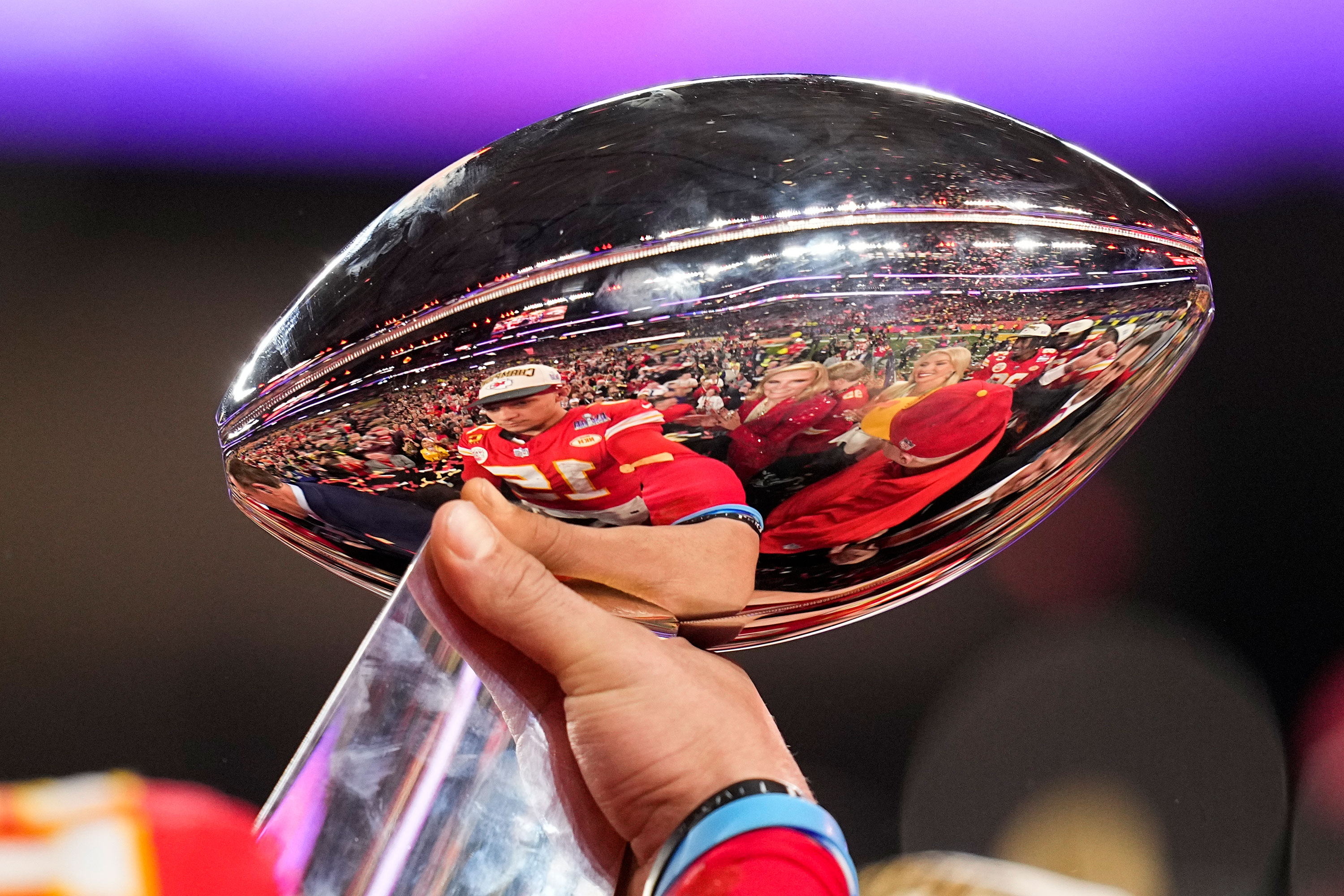 Mahomes is reflected in the Vince Lombardi Trophy.