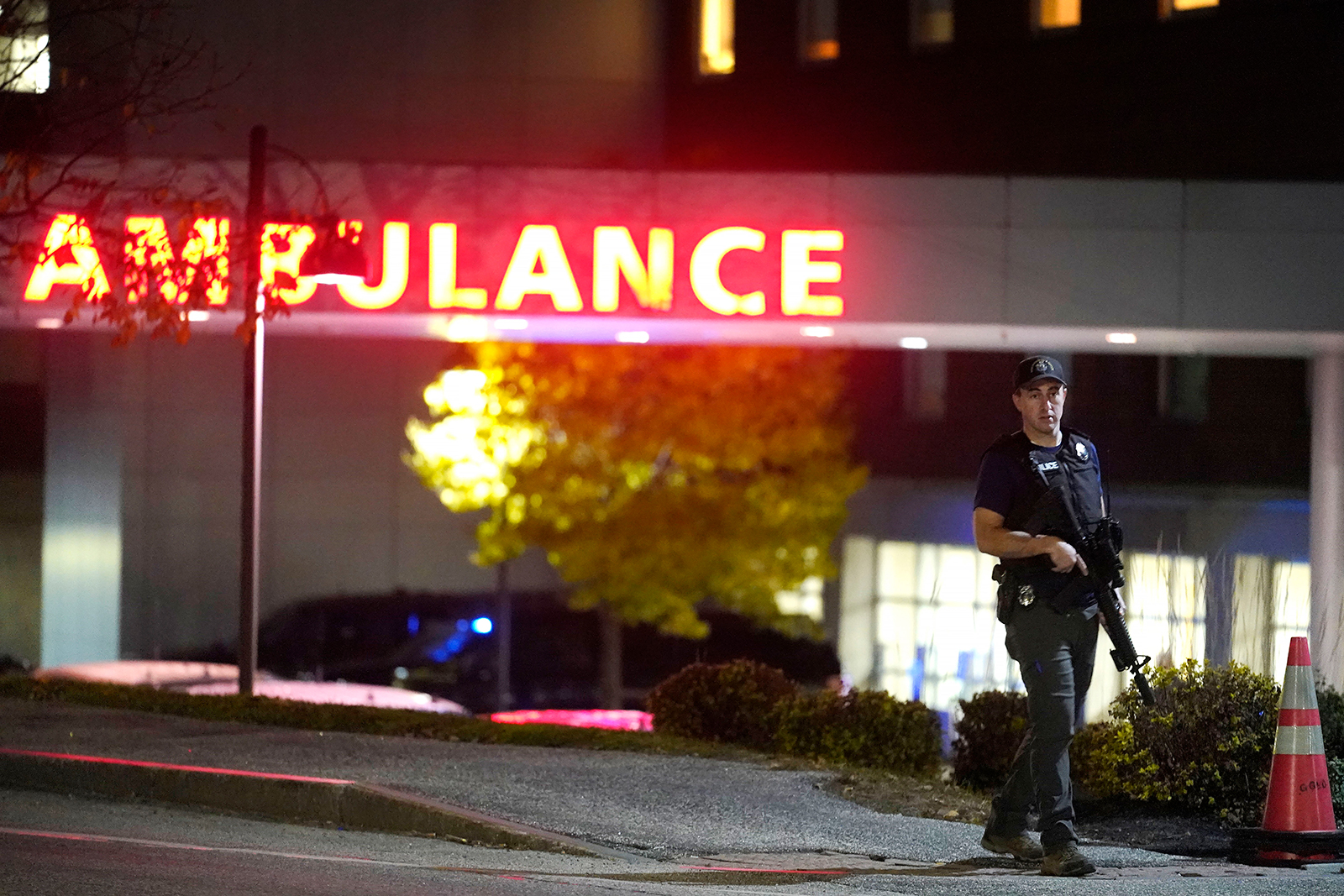 A law enforcement officer carries a rifle outside Central Maine Medical Center during an active shooter situation, in Lewiston, Maine, on October 25.