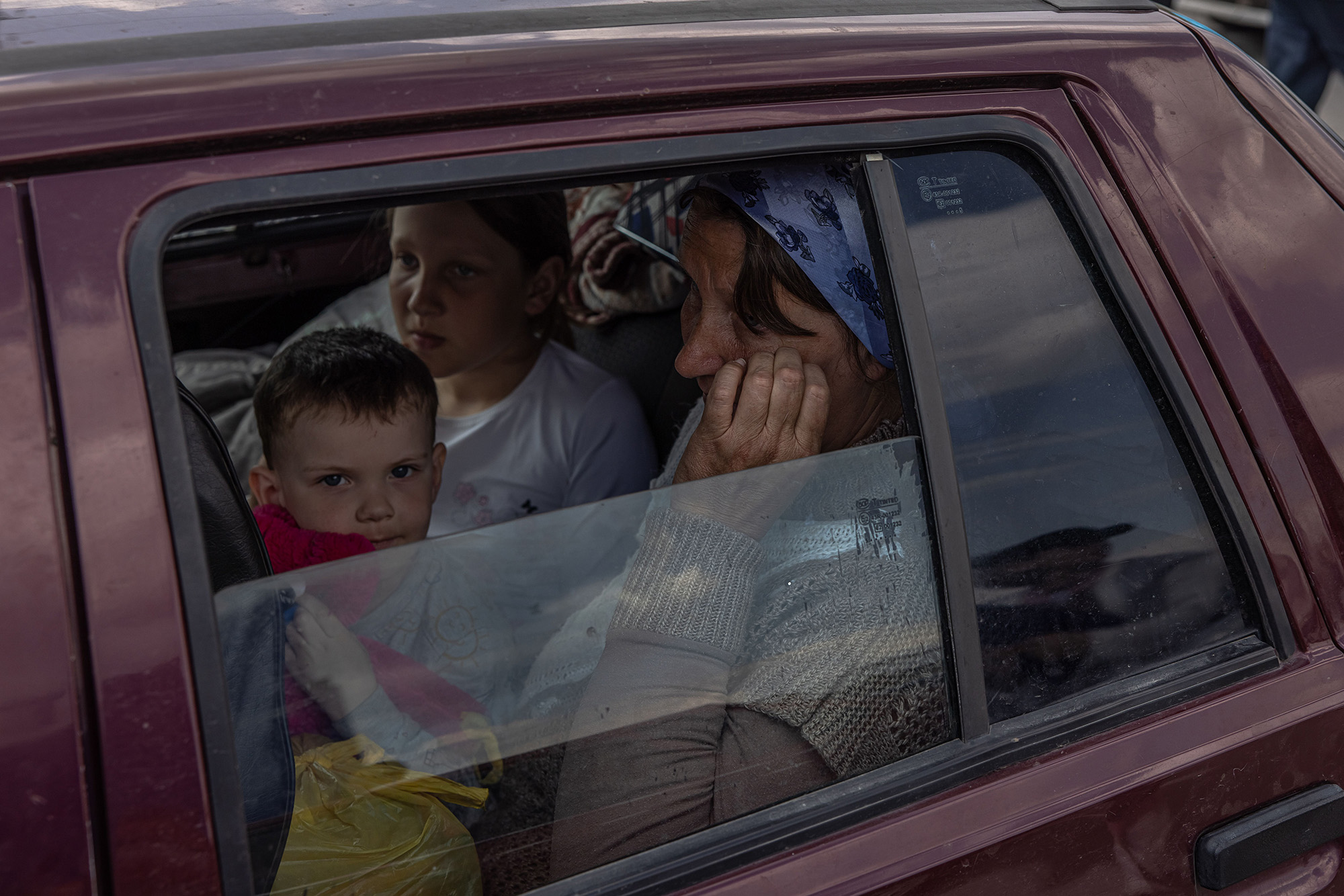 Internally displaced people sit in a car after arriving from the Russian-occupied area in the Kherson region to the evacuation point in Zaporizhzhia, Ukraine, on May 2.