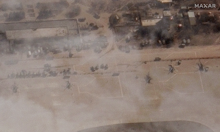 Satelitní snímek od společnosti Maxar Technologies ukazuje řadu ruských vojenských vrtulníků sedících v pondělí na asfaltu.