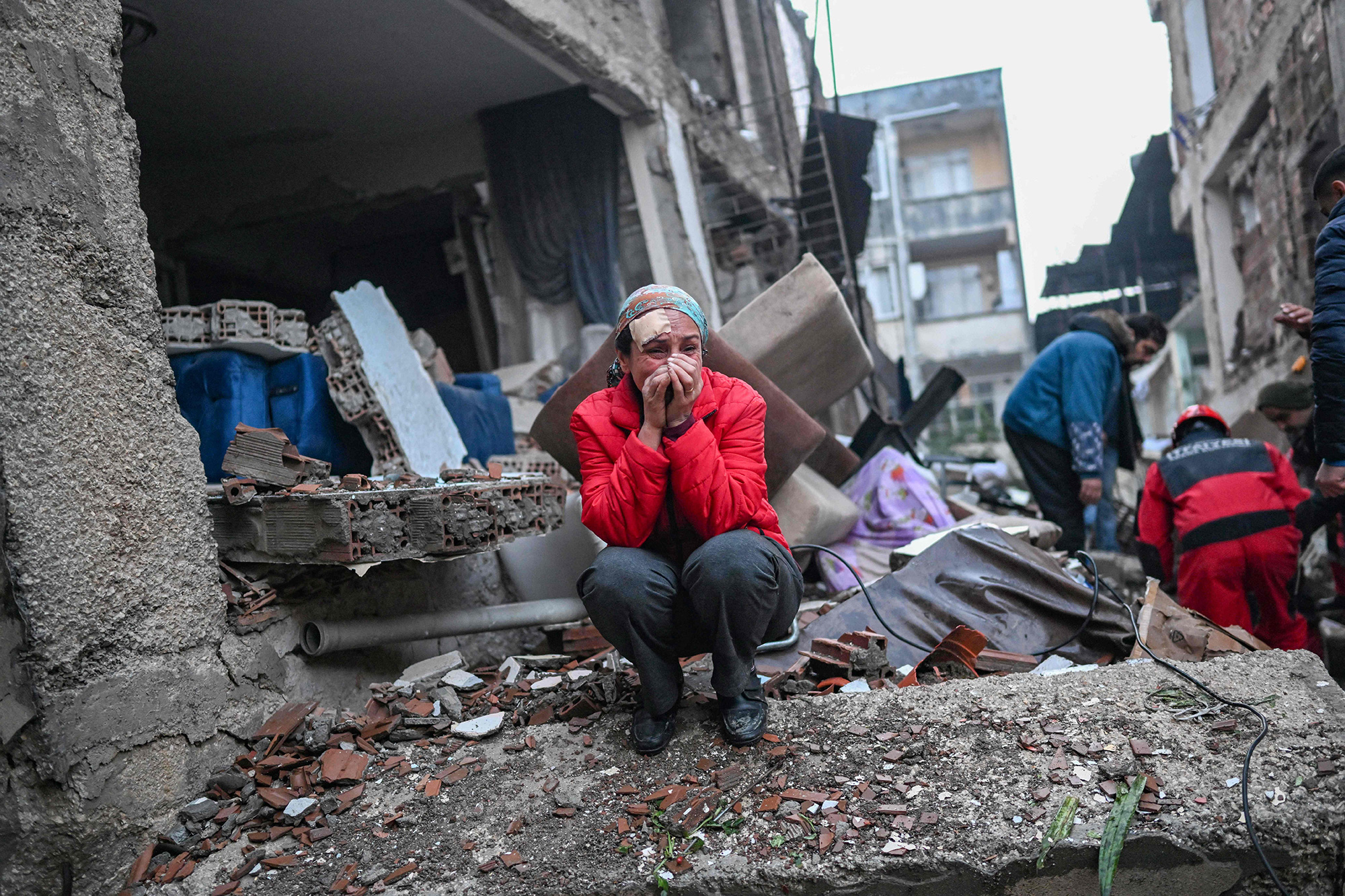 A survivor cries as rescuers look for victims in Hatay, Turkey.