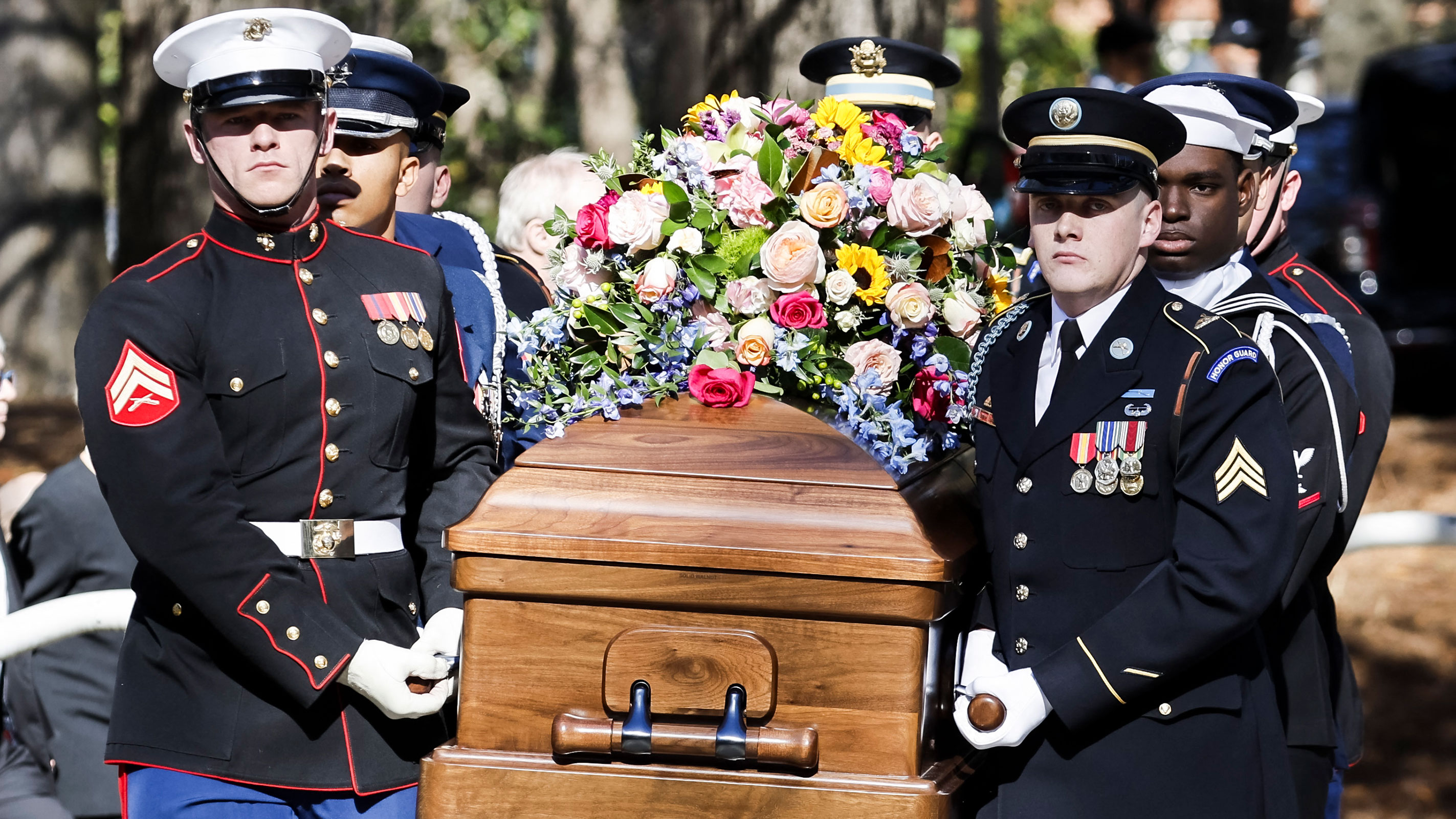 A military honor guard carries the casket of former first lady Rosalynn Carter from the Jimmy Carter Presidential Library and Museum in Atlanta, Georgia, on November 28, en route for an afternoon tribute service at Glenn Memorial Church at Emory University. 