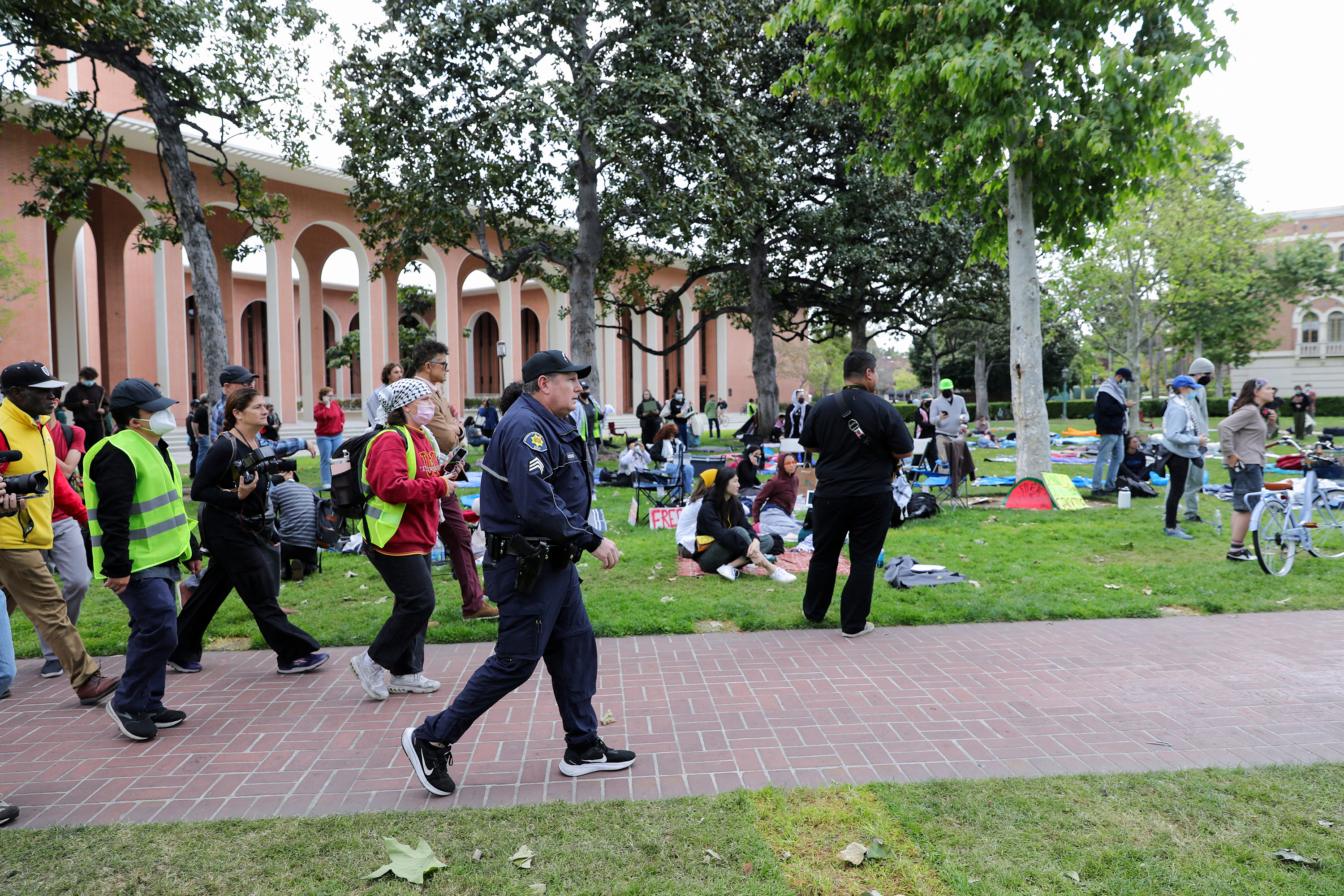 USC Public Safety officer walks to inform students that they must disperse, as they build a protest encampment in support of Palestinians, at the University of Southern California's Alumni Park on April 24, in Los Angeles, California.