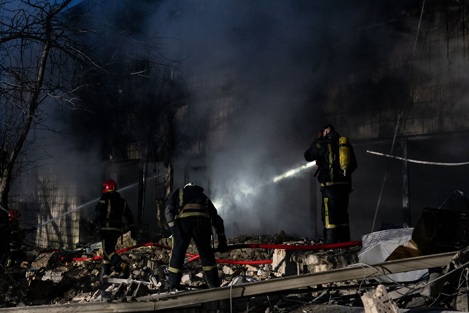 Emergency crews respond to the scene of an airstrike near Kyiv's TV tower on March 1. The nearby Babyn Yar Holocaust memorial site was also hit during the attack.