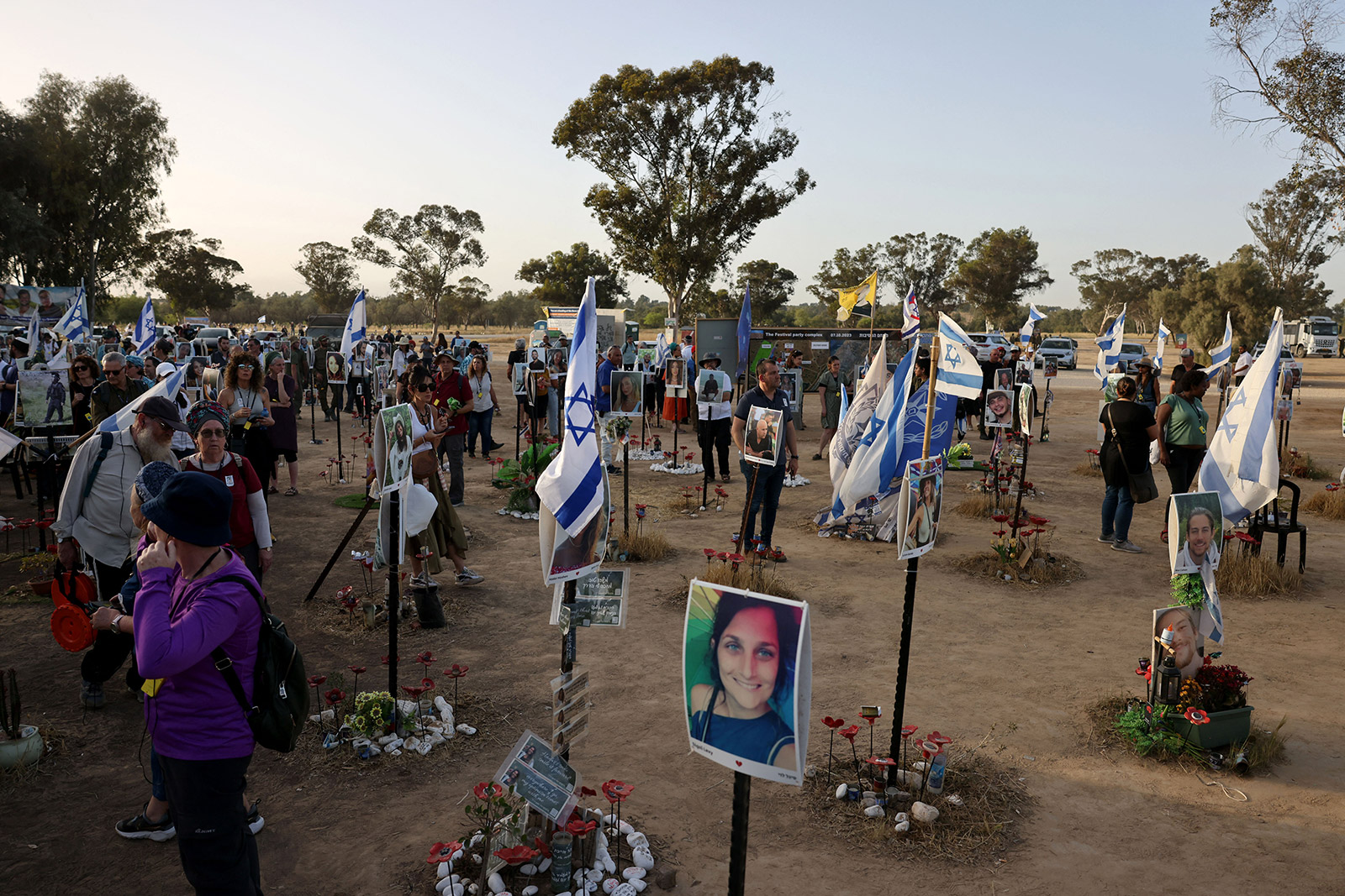 Visitors pay their respects at a memorial bearing portraits of people taken hostage or killed in the Hamas attack in southern Israel on May 9, 2024. 