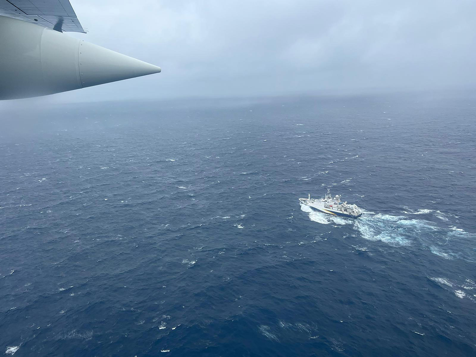 A Coast Guard HC-130 Hercules airplane flies over French research vessel L’Atalante about 900 miles east of Cape Cod during the search for the Titan submersible on June 21.