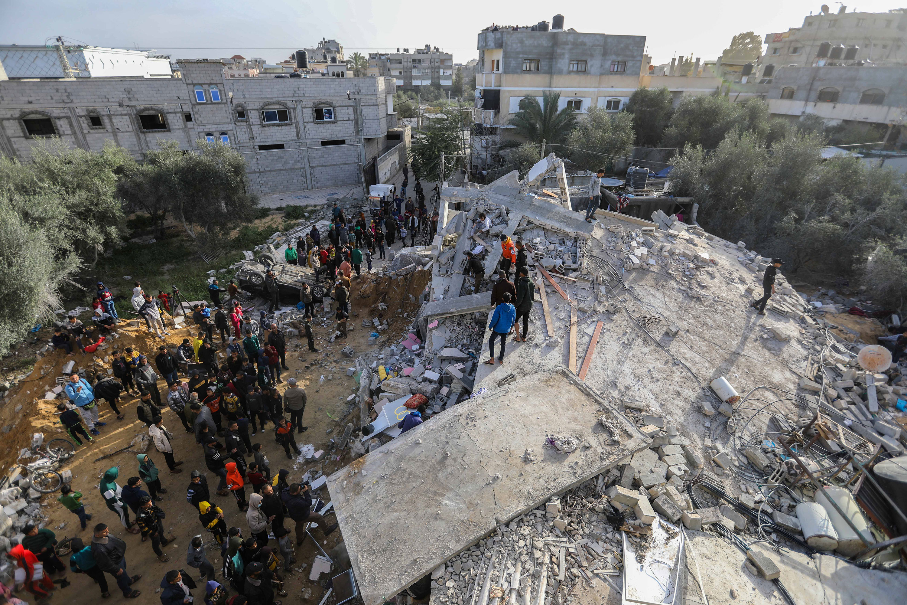 People inspect damage and recover items from their homes following Israeli air strikes in Rafah, Gaza, on March 3. 