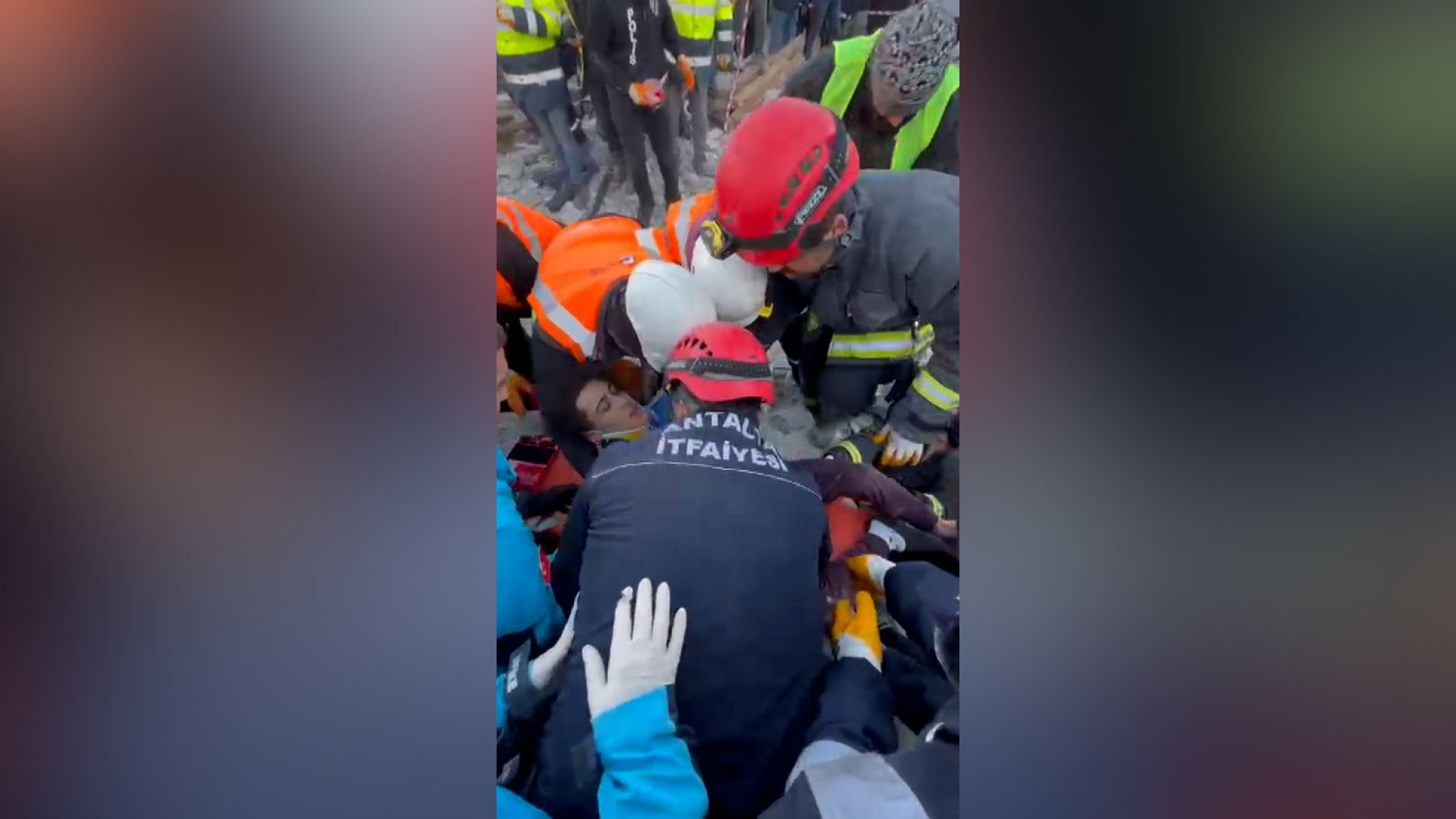 Fuat Camber is helped by rescuers after being pulled from the rubble.