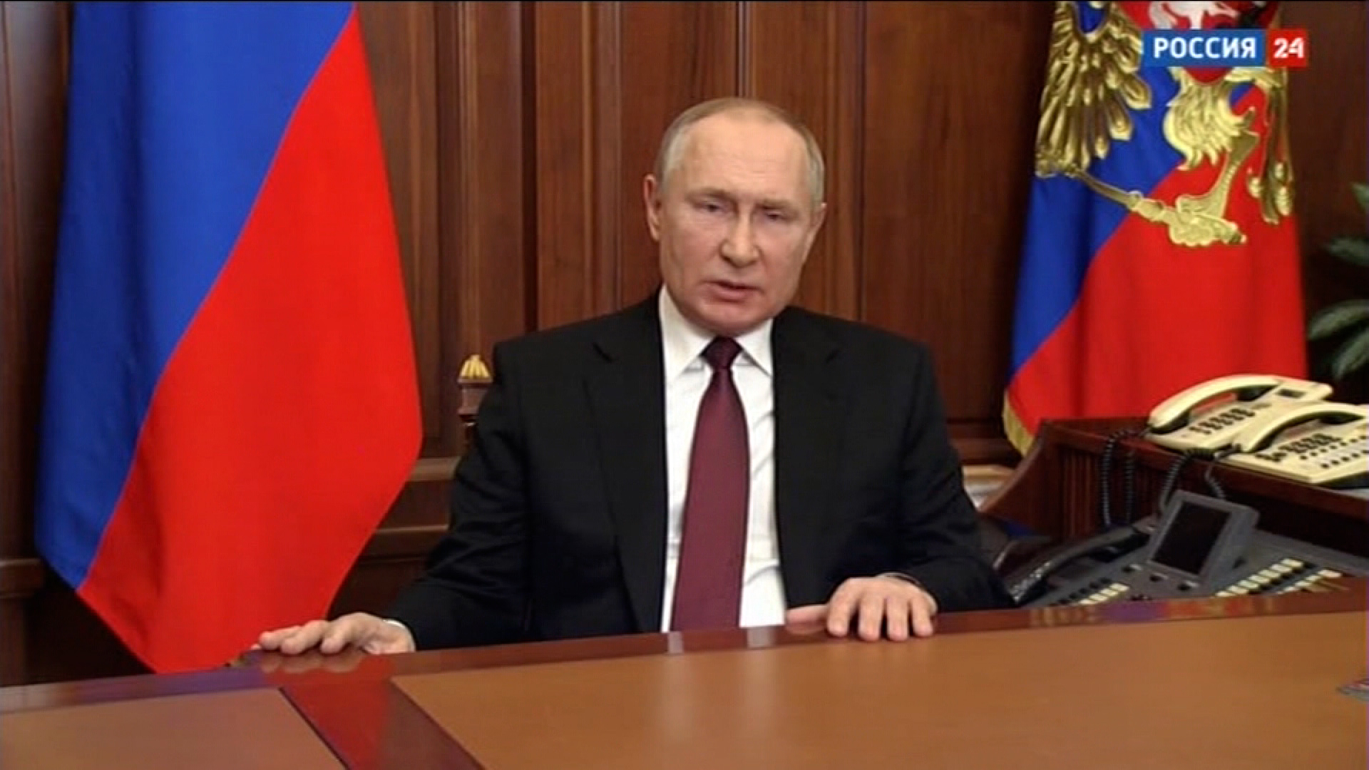 Russian state television broadcasts an address by Russian President Vladimir Putin on February 24.