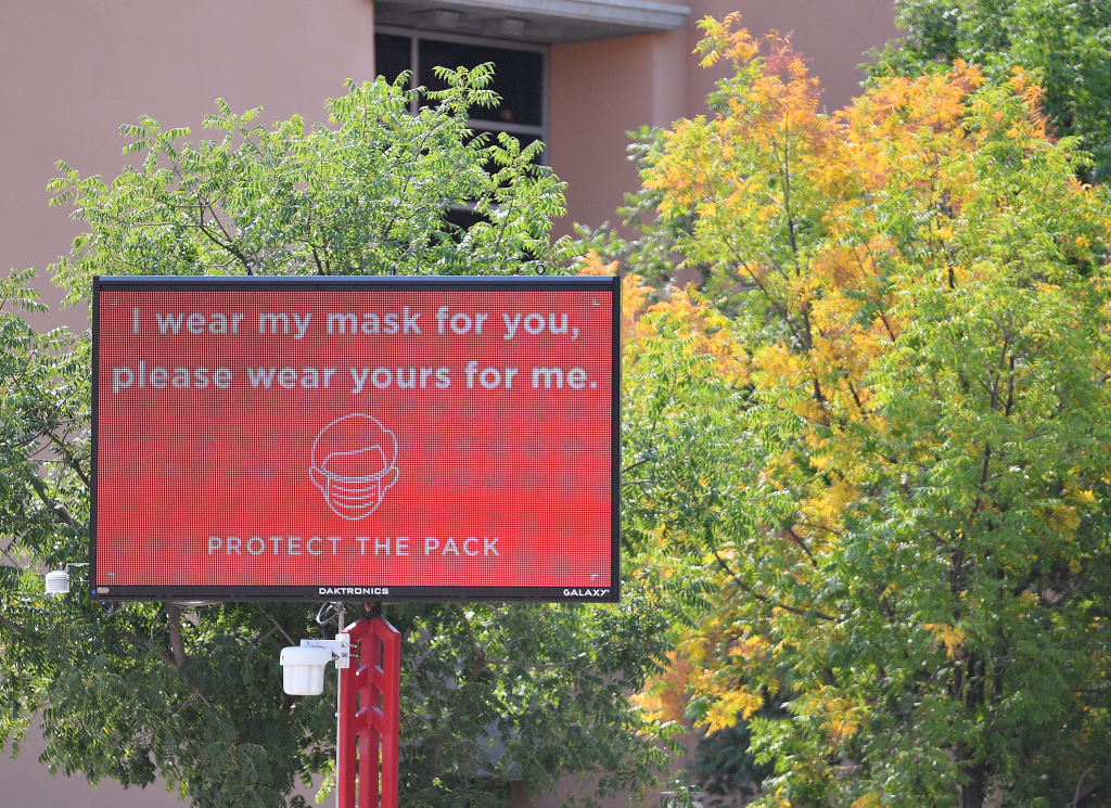 A sign at the University of New Mexico encourages students to wear a mask.