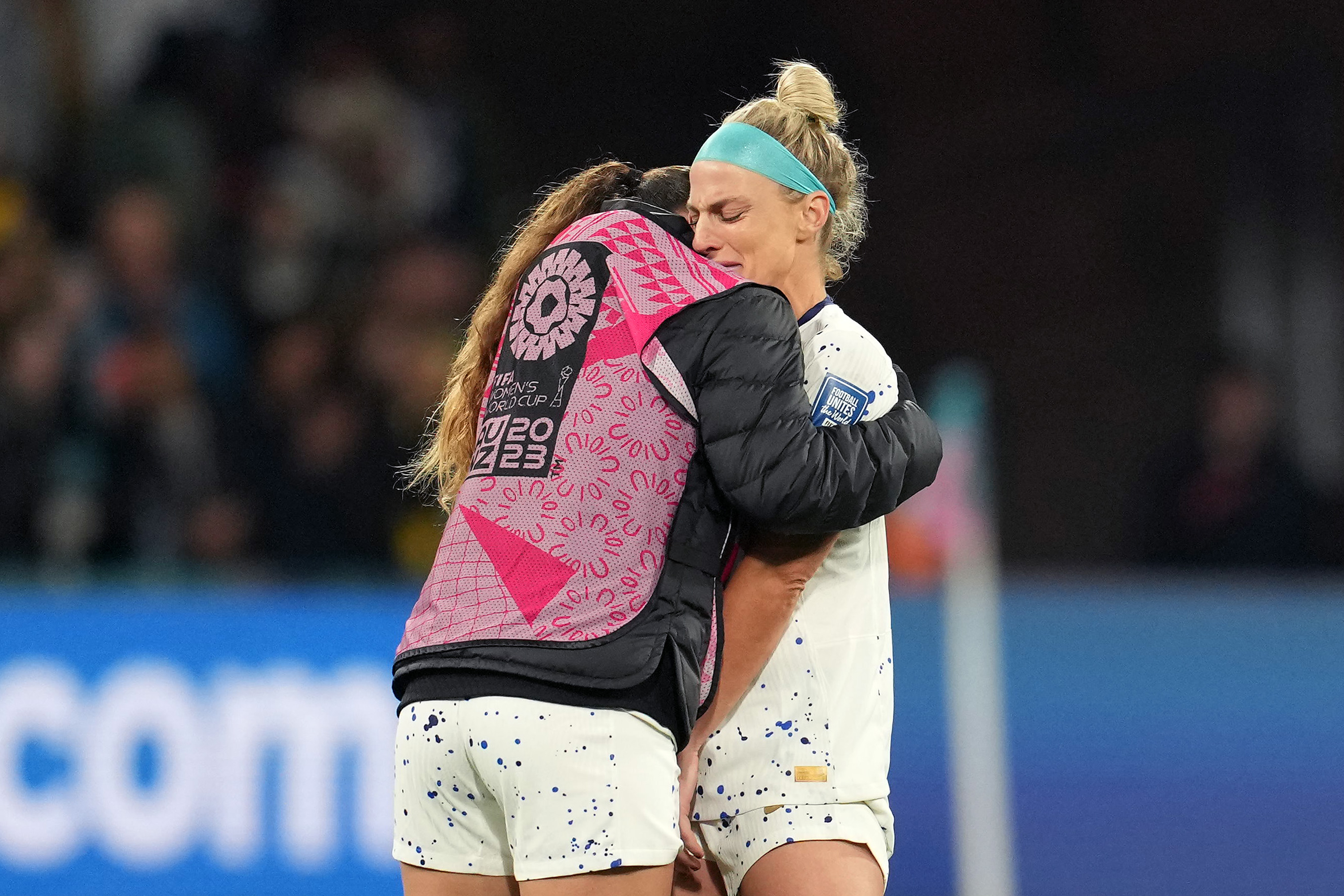 Julie Ertz is comforted after the US team was defeated in a penalty shootout.