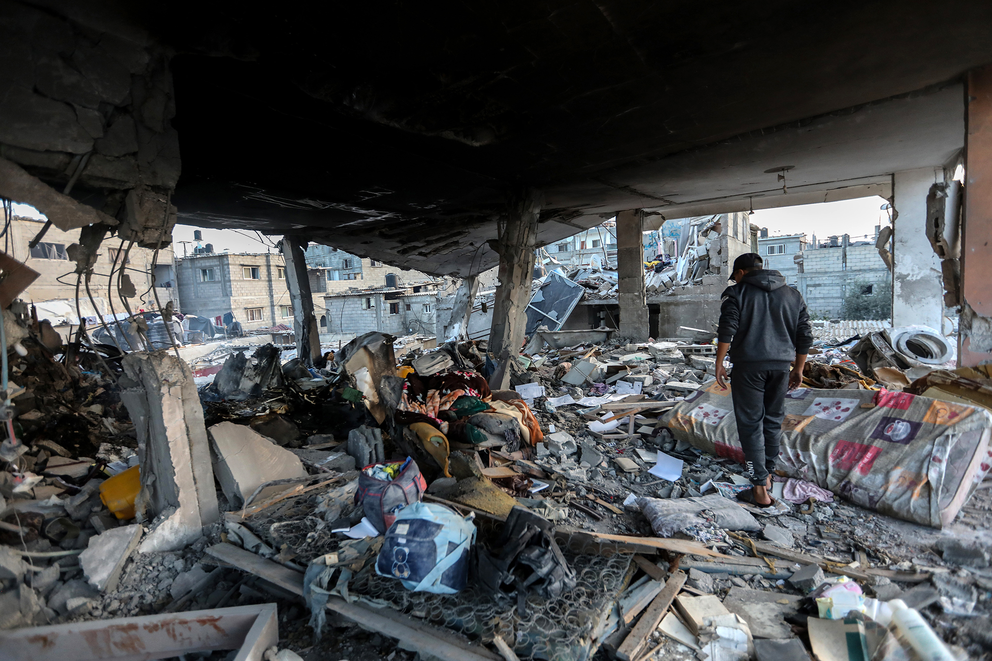 A Palestinian man inspects destruction caused by air strikes on December 3, in Khan Younis, Gaza. 
