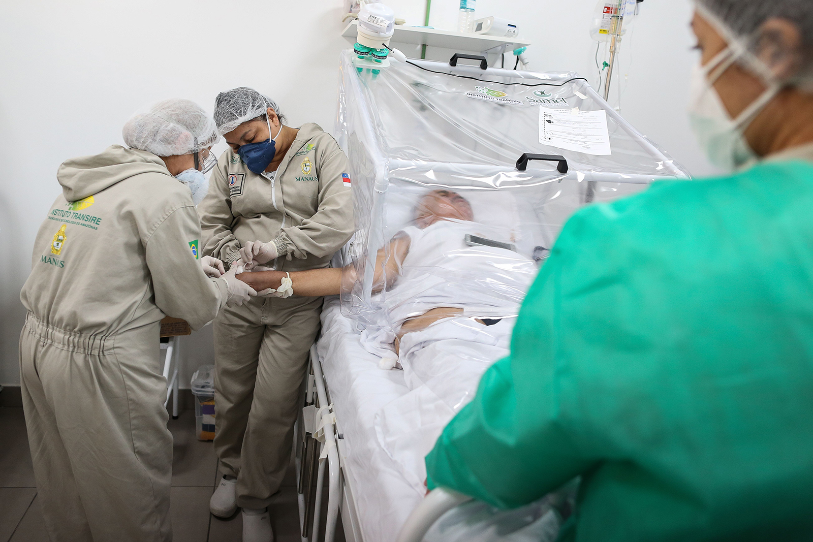 Health workers assist a Covid-19 patient at the Gilberto Novaes Municipal Hospital in Manaus, Brazil on June 8.