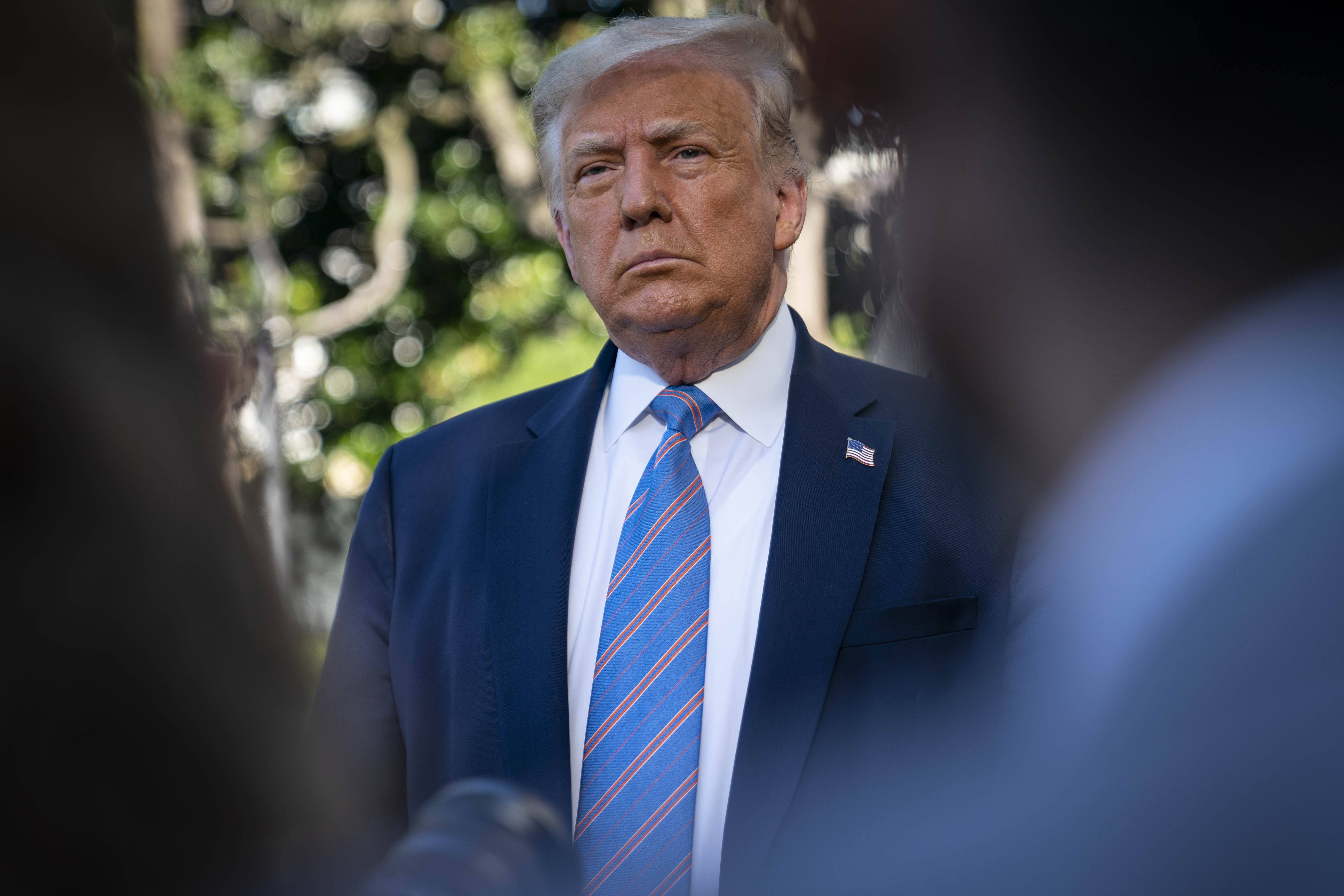 President Donald Trump speaks with members of the media on July 29 at the White House.