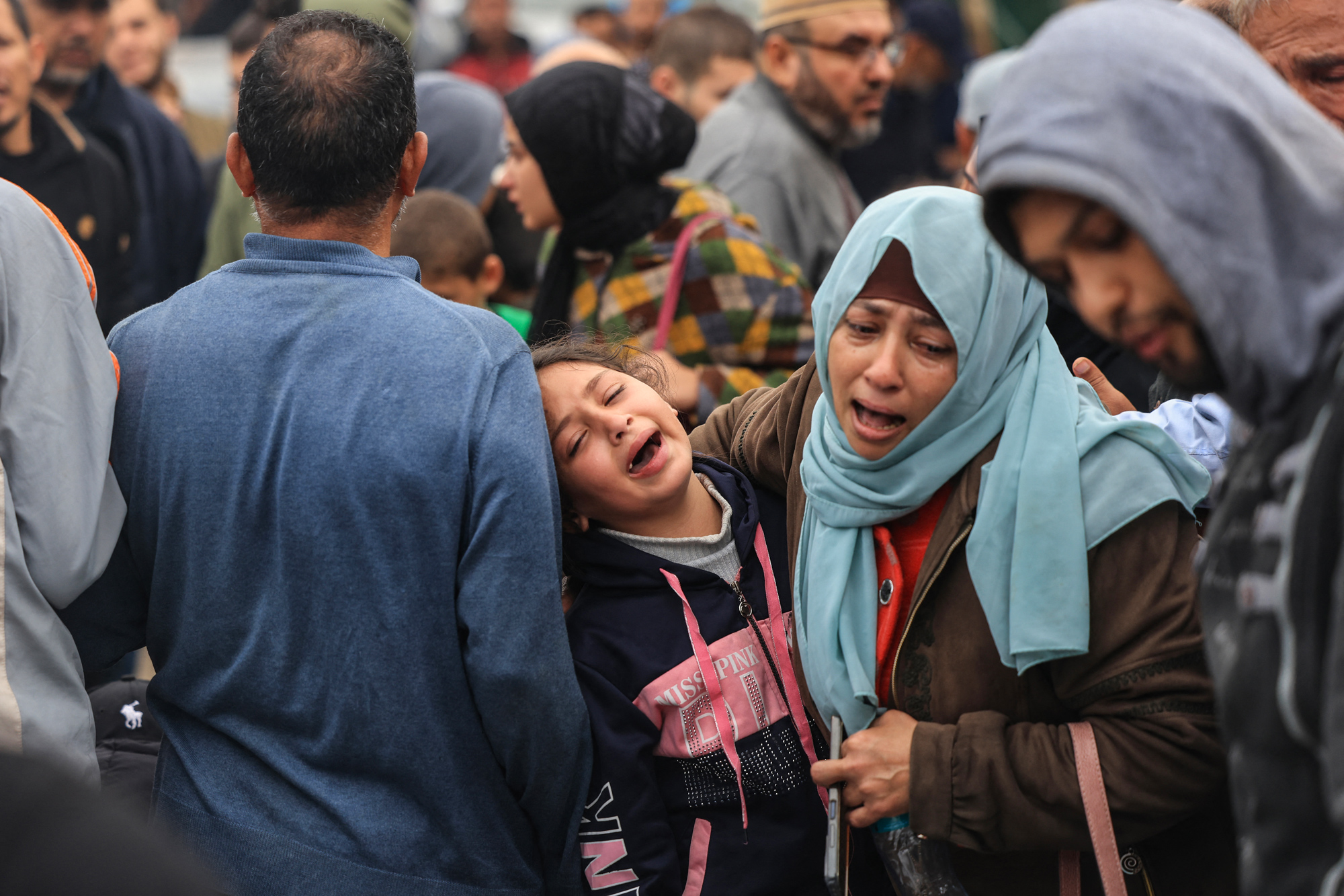 Palestinians mourn the death of loved ones following Israeli bombardment in southern Gaza on December 5.