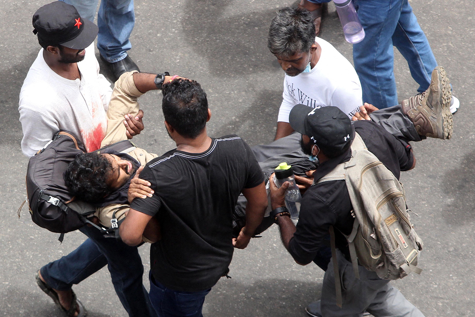 Protesters carry an injured man in Colombo on July 9.