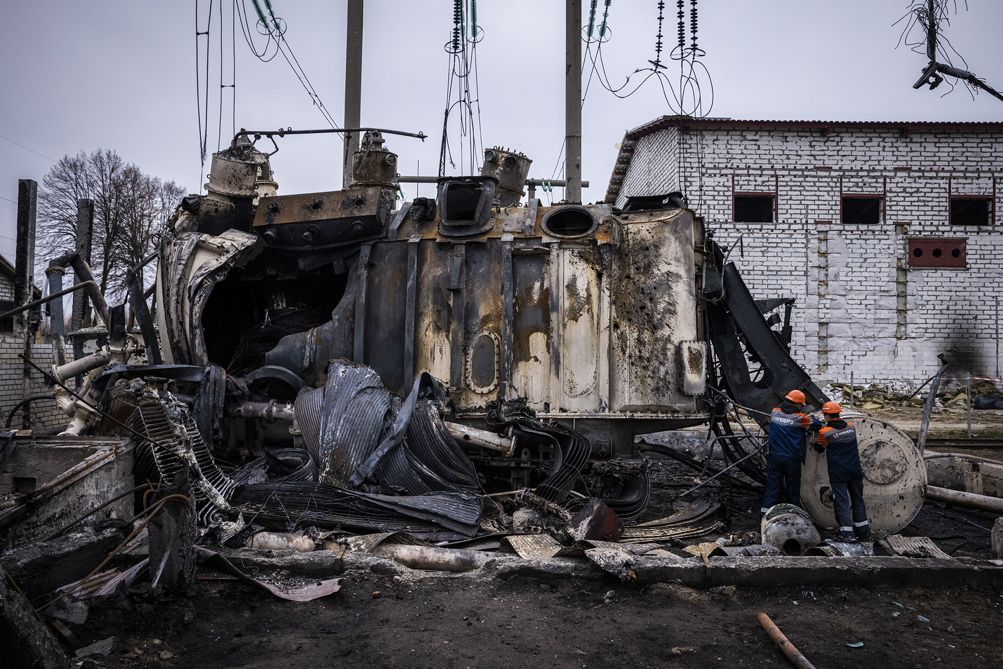 Workers dismantle an autotransformer in central Ukraine which stands completely destroyed after the Ukrenergo high voltage power substation was hit by a missile strike on October 17.