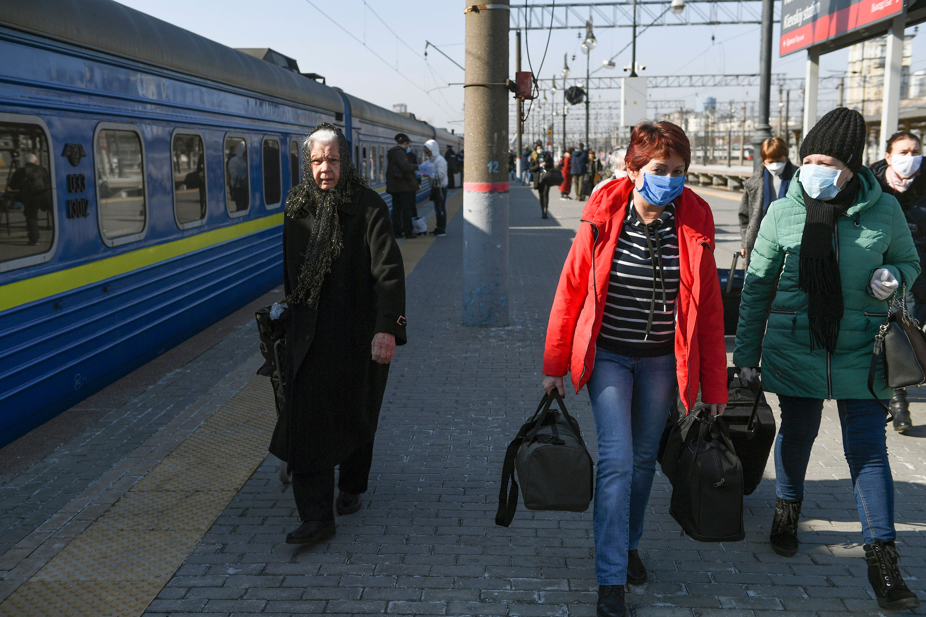 People walk along a platform after arriving by a special train from Ukraine at Kievsky Railway Station in Moscow on March 28.