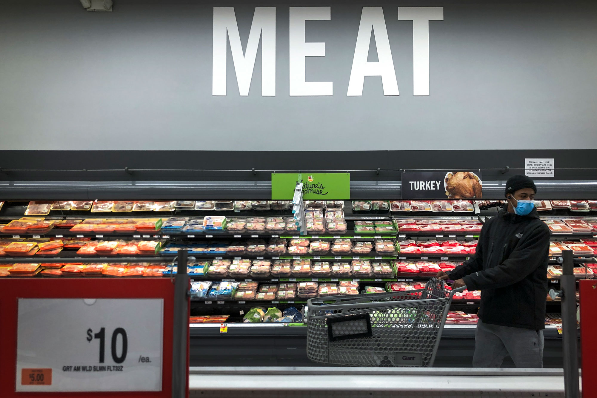 A man shops in the meat section at a grocery store on April 28 Washington.