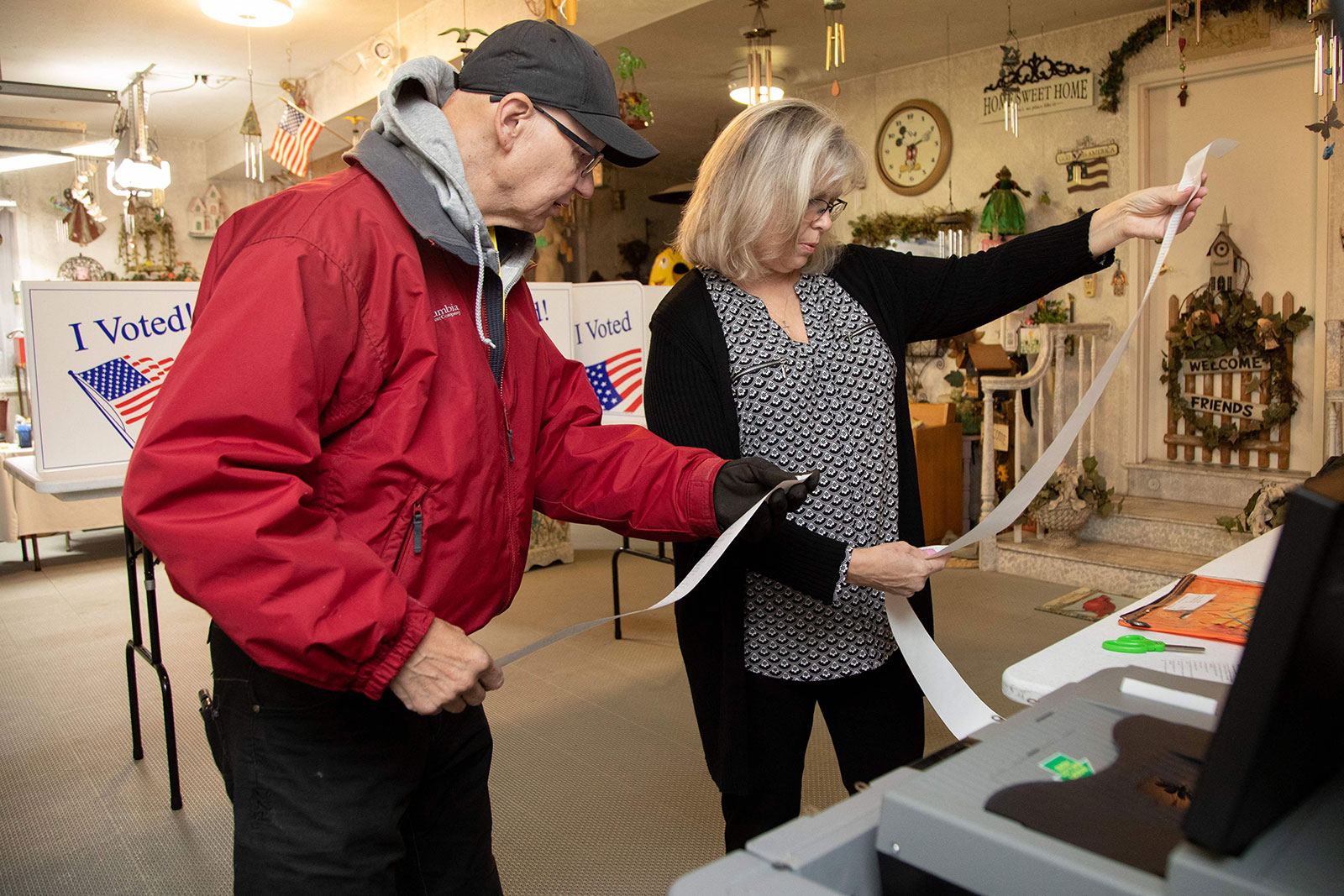 David Walchesky, left, judge of elections, and Evelyn Cain, majority inspector, prepare the ballot scanner at a polling place inside a private resident's garage in Pittsburgh on Tuesday. 