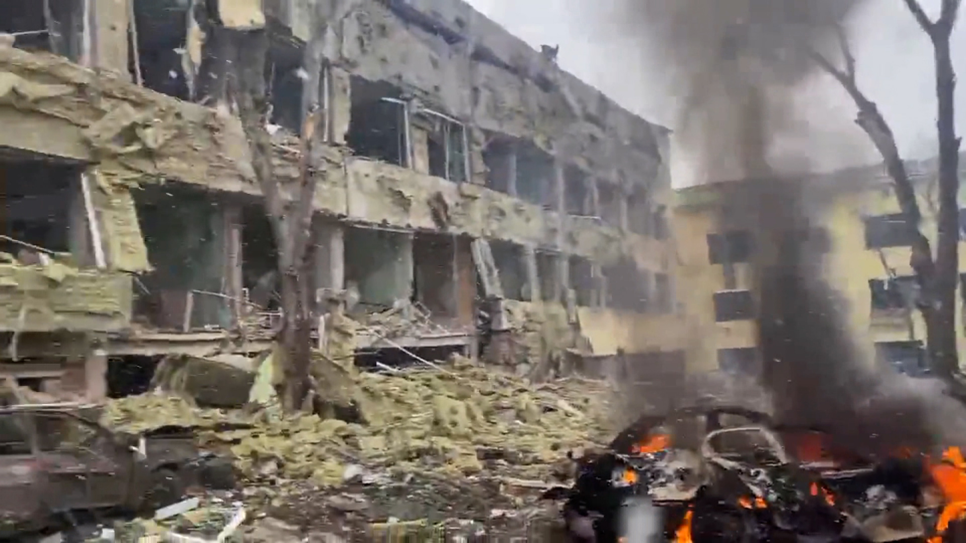 A vehicle burns at the site of a maternity hospital that was bombed in this image taken from video.