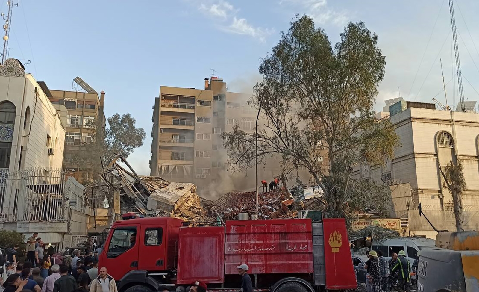 Emergency and security personnel inspect the site of a strike that hit a building annexed to the Iranian embassy in Syria's capital Damascus on April 1.