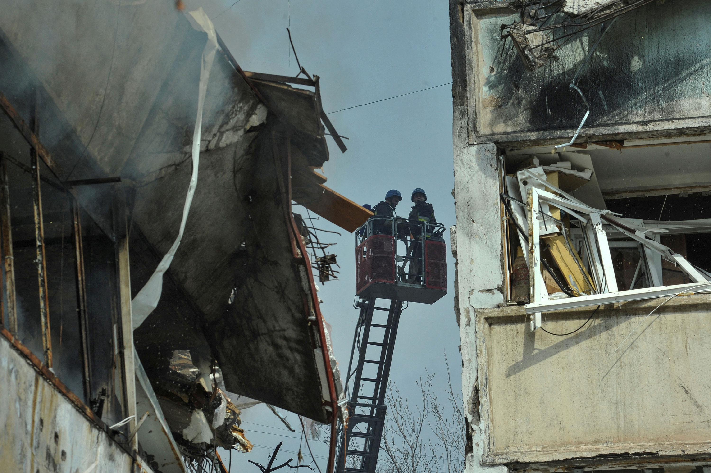 Rescuers work at a site of a residential building damaged by a Russian missile strike in Zaporizhzhia on March 22. 