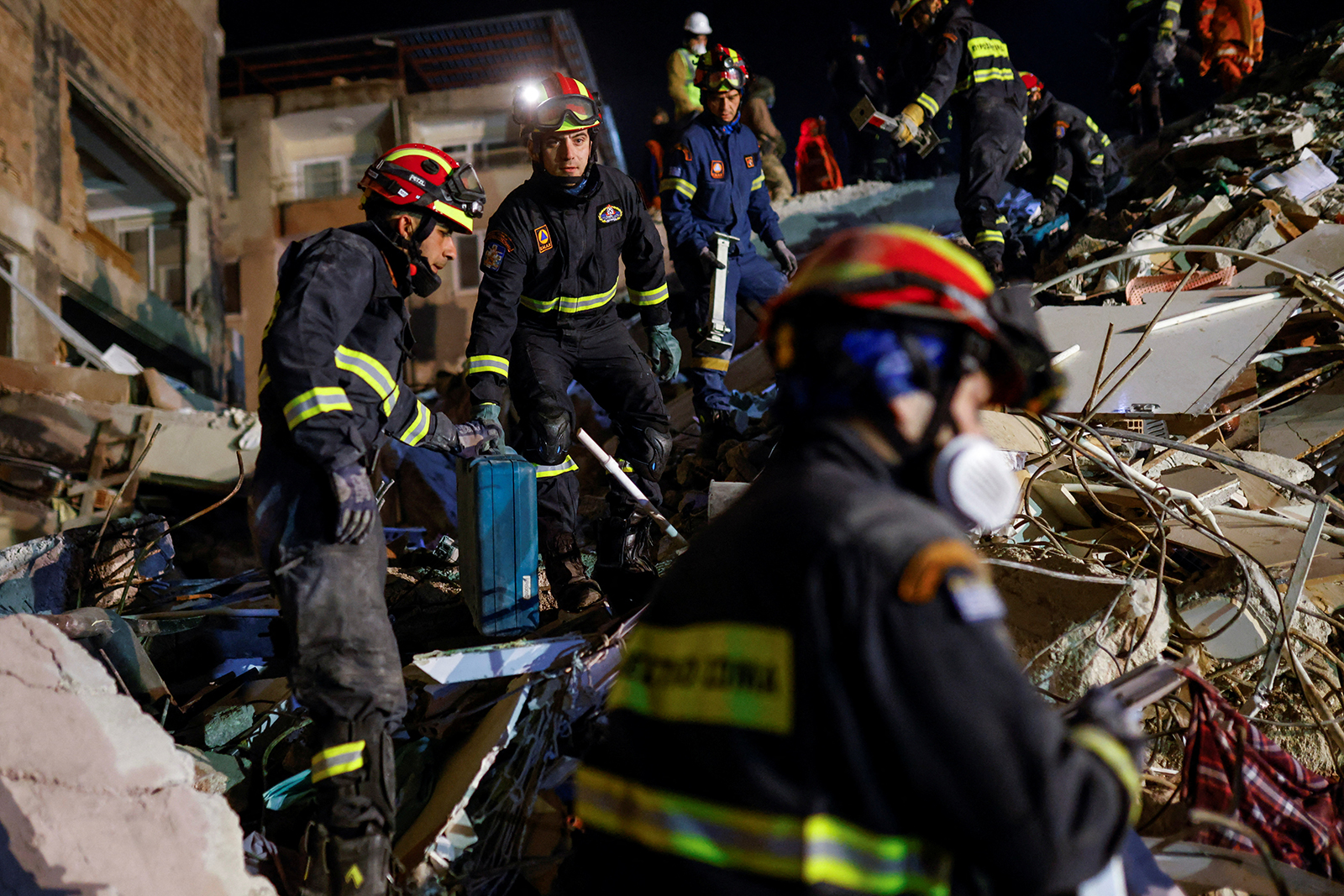 Members of a rescue team work on the site of a collapsed building, as the search for survivors continues in Hatay, Turkey on February 11.