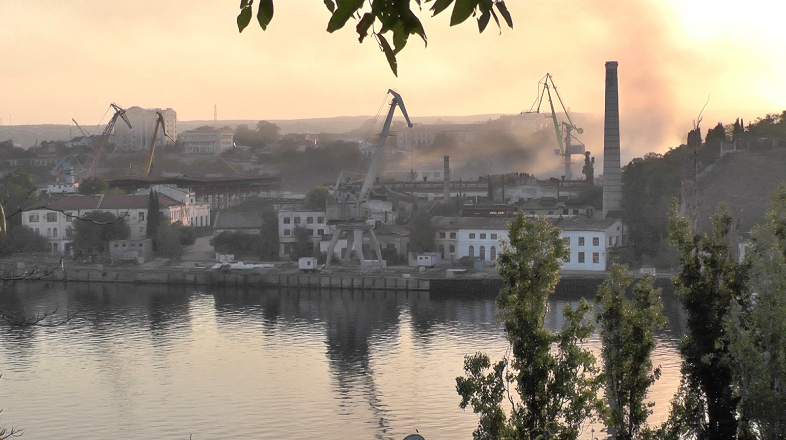 Smoke rises from the shipyard that was reportedly hit by Ukrainian missile attack in Sevastopol, Crimea, in this still image from video taken on September 13.