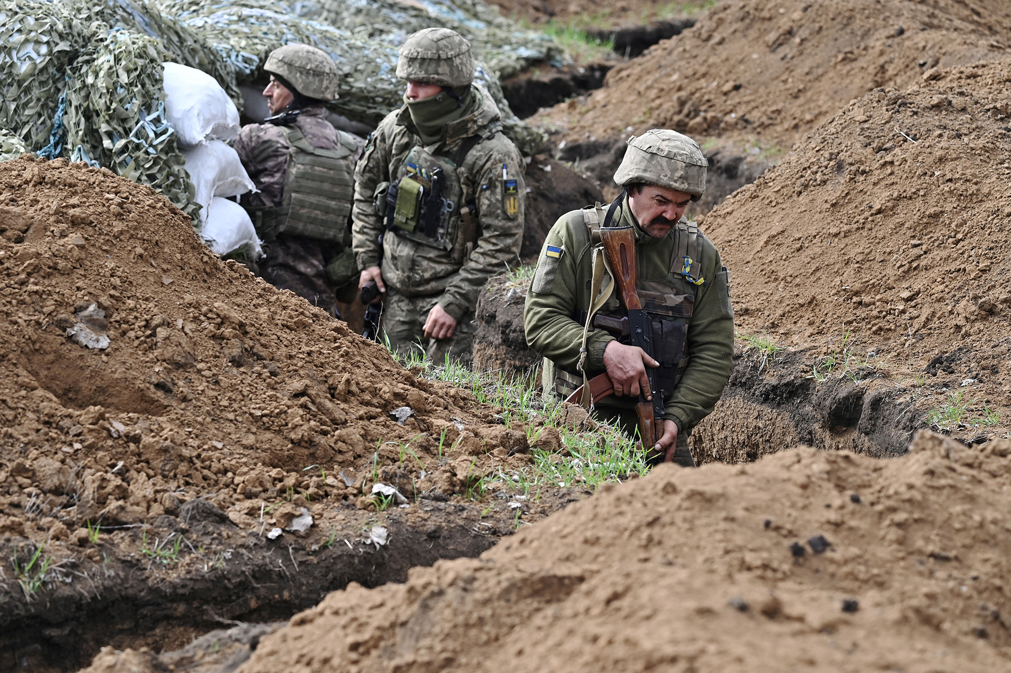 Ukrainian soldiers stand in trenches near Bakhmut, Ukraine, on April 8. 
