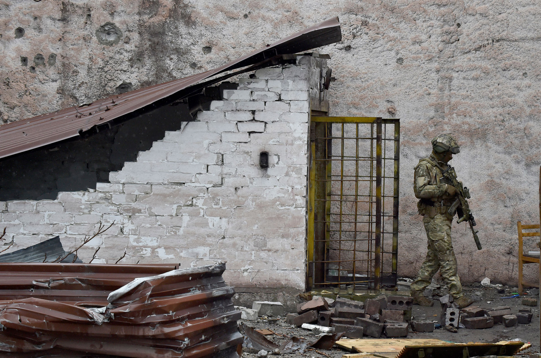 A Russian serviceman patrols the destroyed part of the Ilyich Iron and Steel Works in Mariupol on May 18.