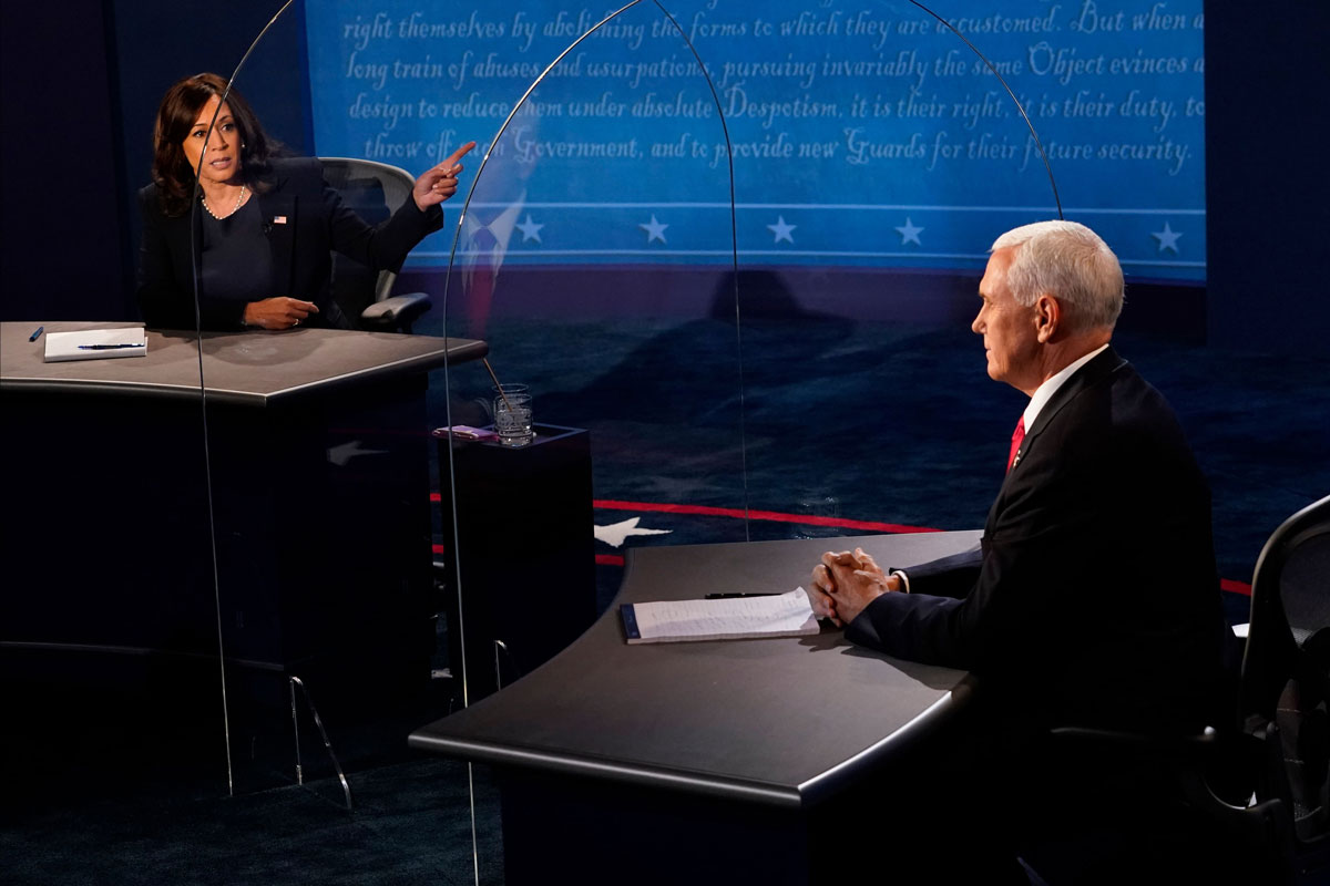 Vice President Mike Pence listens as Democratic vice presidential candidate Kamala Harris speaks during the vice presidential debate in Kingsbury Hall at the University of Utah on October 7.