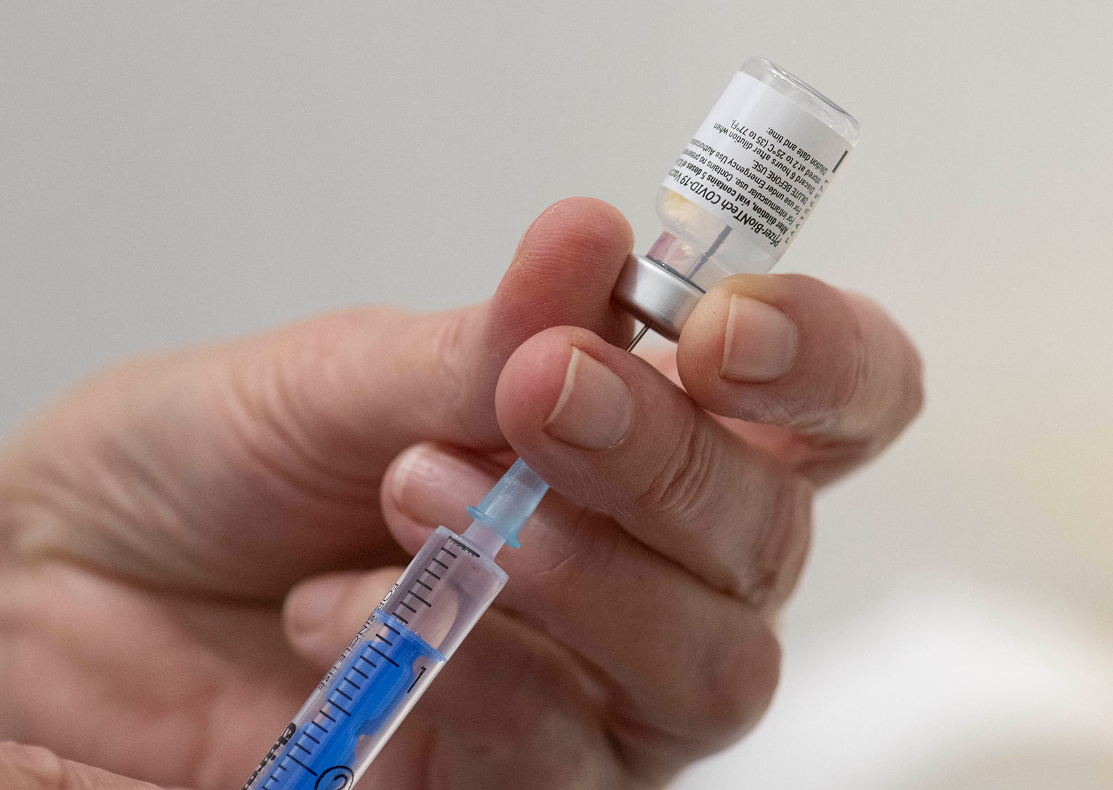 A medical worker fills a syringe with a dose of the Pfizer-BioNTech Covid-19 vaccine at the Robert Bosch hospital in Stuttgart, Germany, on December 27.