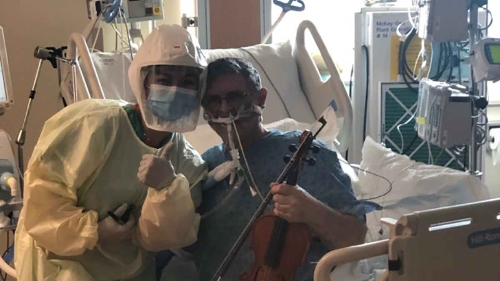 Ciara Sase, RN, with Grover Wilhelmsen as his holds a musical instrument.