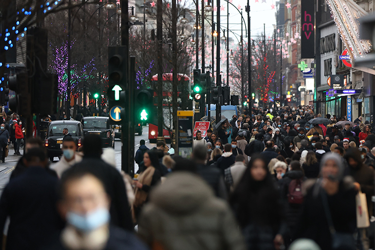  Shoppers walk along Oxford Street on December 24, 2021 in London, England.