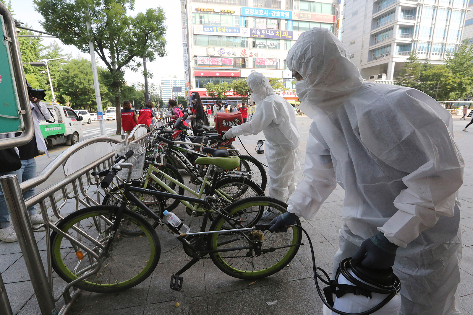 Workers and volunteers disinfect as a precaution against the coronavirus on a street in Goyang, South Korea, on August 25.
