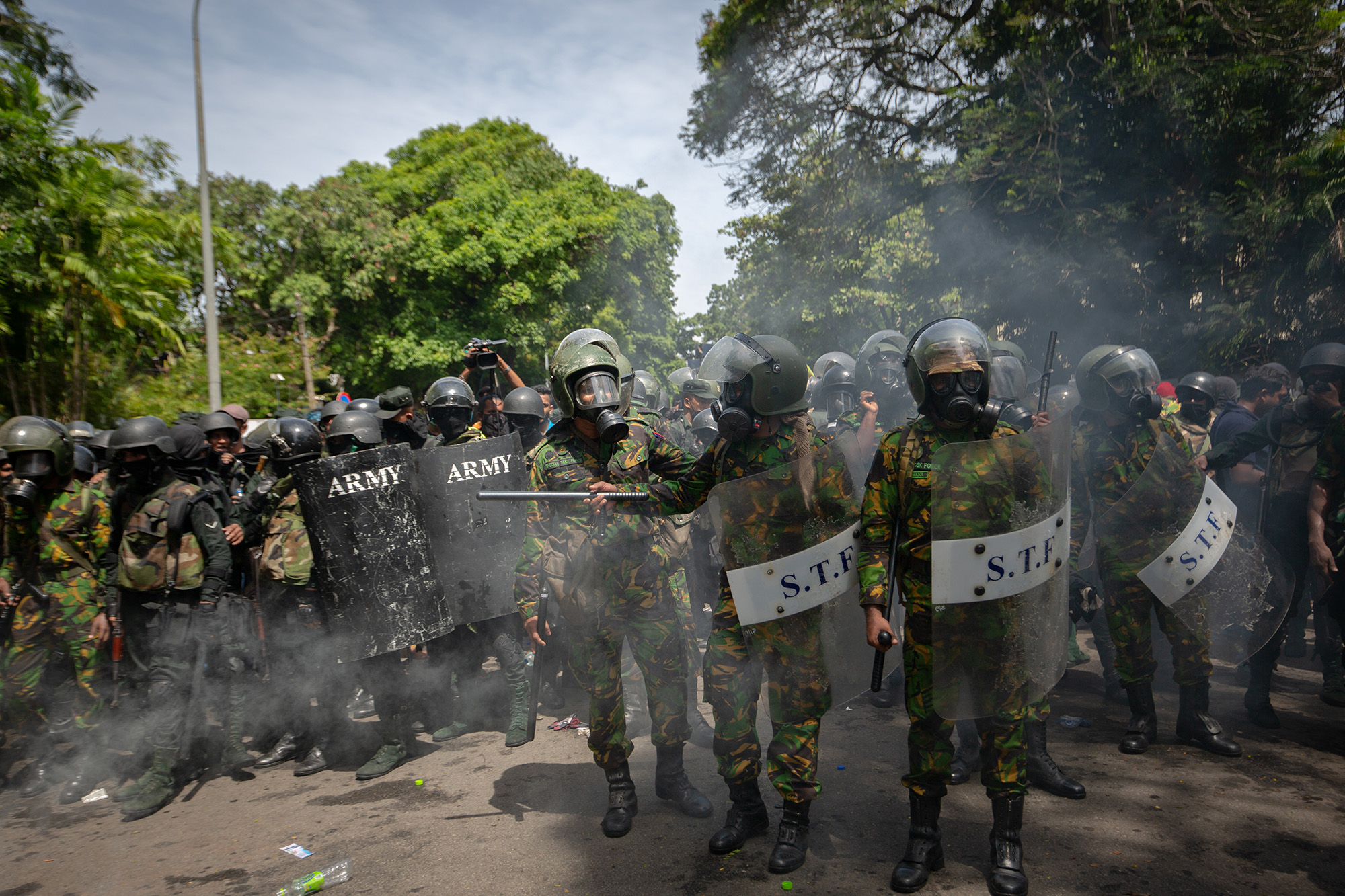 Military personnel in gas masks stand guard during a protest by people seeking the ouster of Sri Lanka's Prime Minister Ranil Wickremesinghe amid the ongoing crisis in Colombo on July 13.