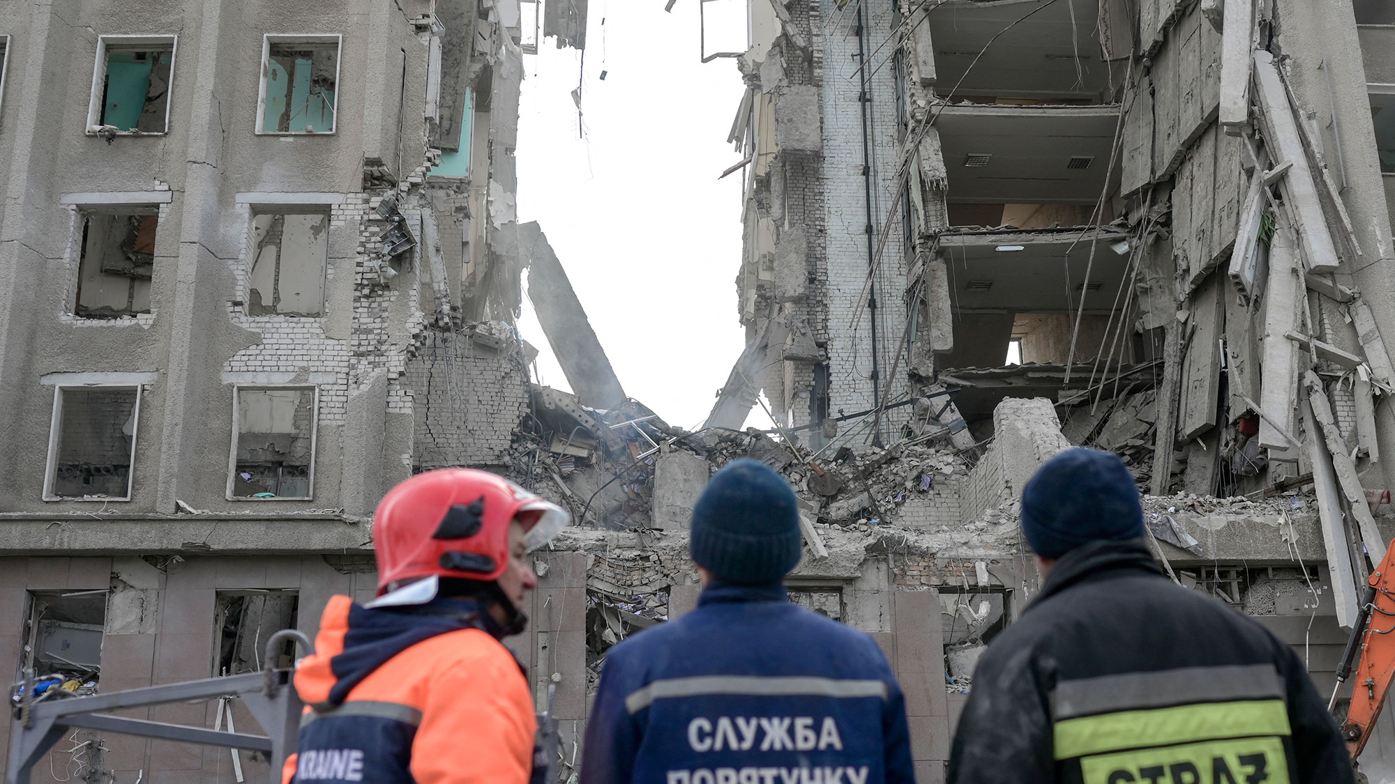 Rescue workers look at the rubble of government building hit by Russian rockets in Mykolaiv on March 29.