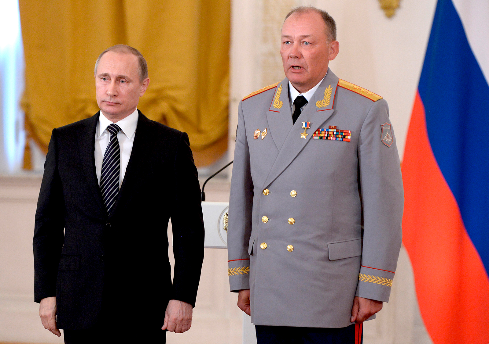 In this swimming pool photo taken on Thursday, March 17, 2016, Russian President Vladimir Putin, left, poses with General Alexander Dvornikov during an awards ceremony in the Kremlin in Moscow, Russia. 