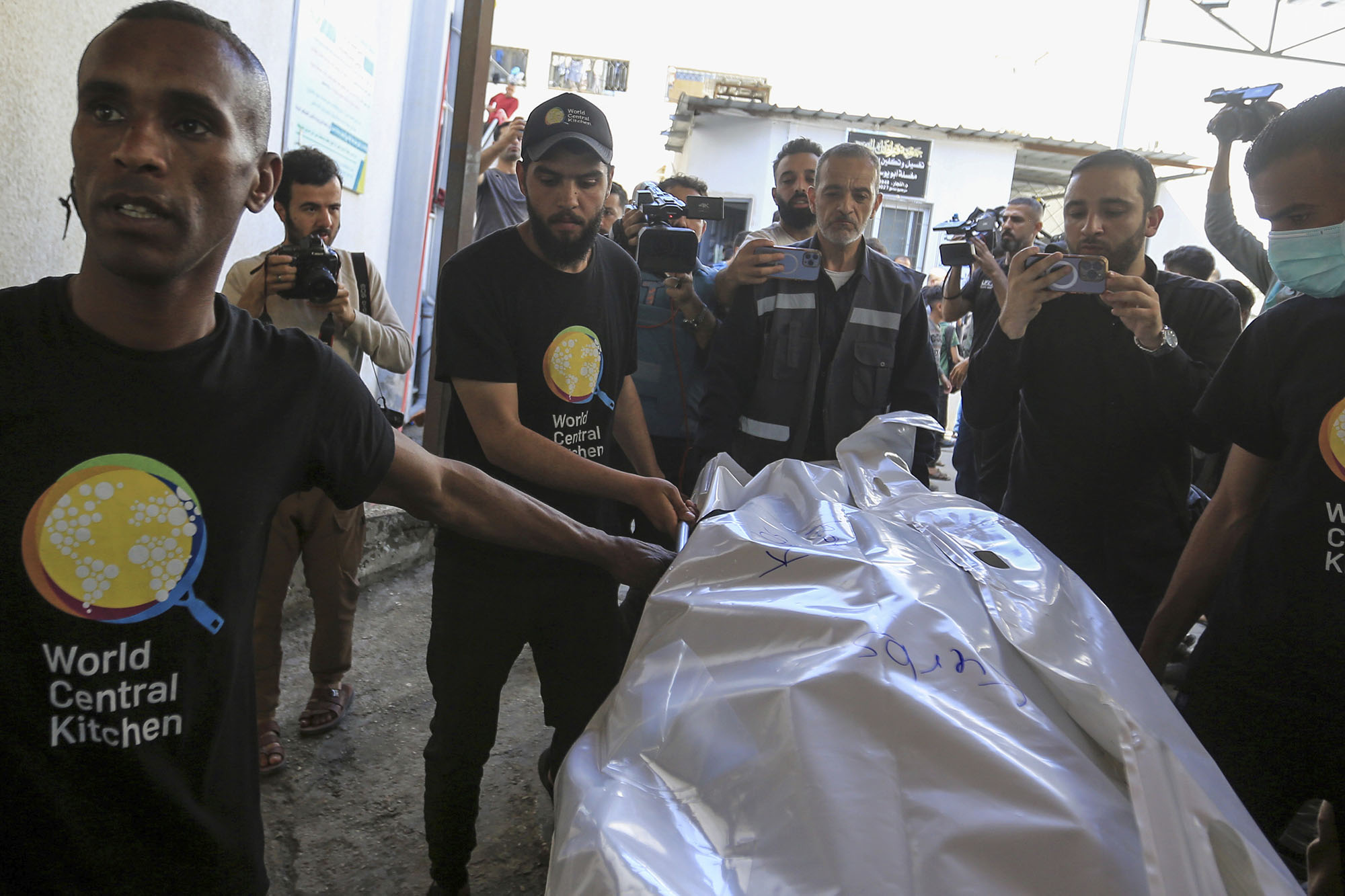 Members of the World Central Kitchen aid group transports the body of one of the staff members killed in an Israeli air strike out of the morgue of Abu Youssef Al-Najjar Hospital in Rafah, Gaza, on April 3.