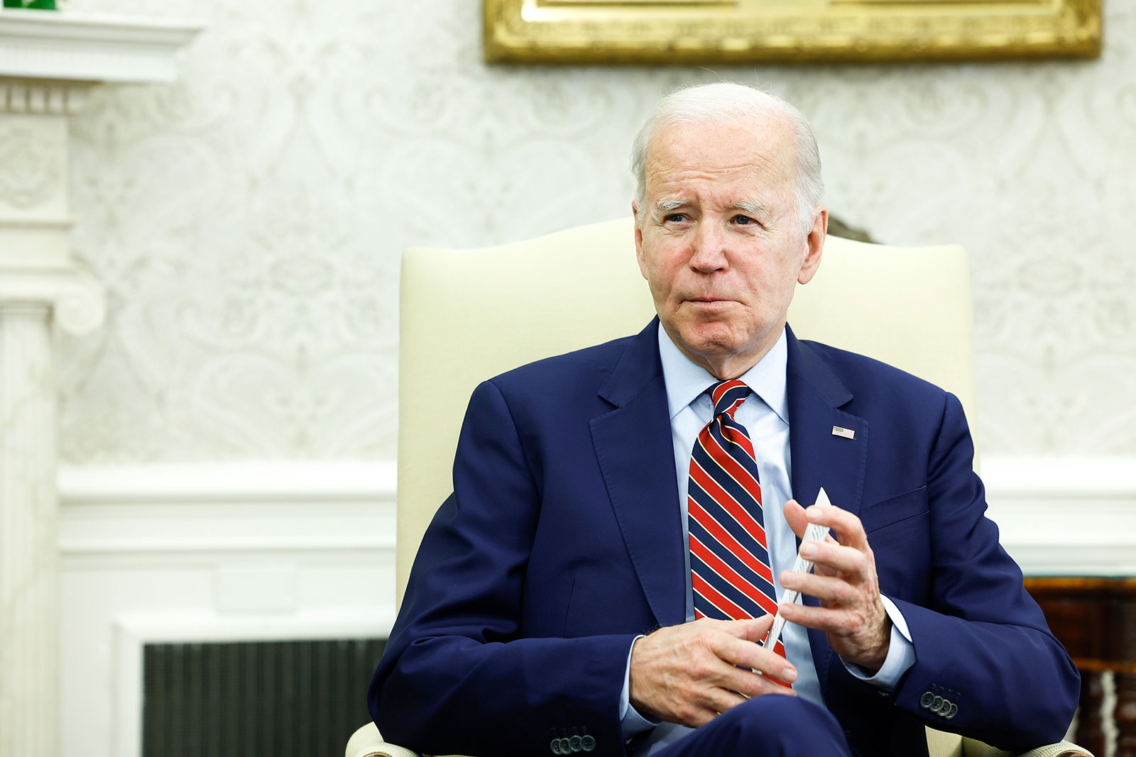 President Joe Biden speaks to reporter\ in the Oval Office  on Friday, May 12.
