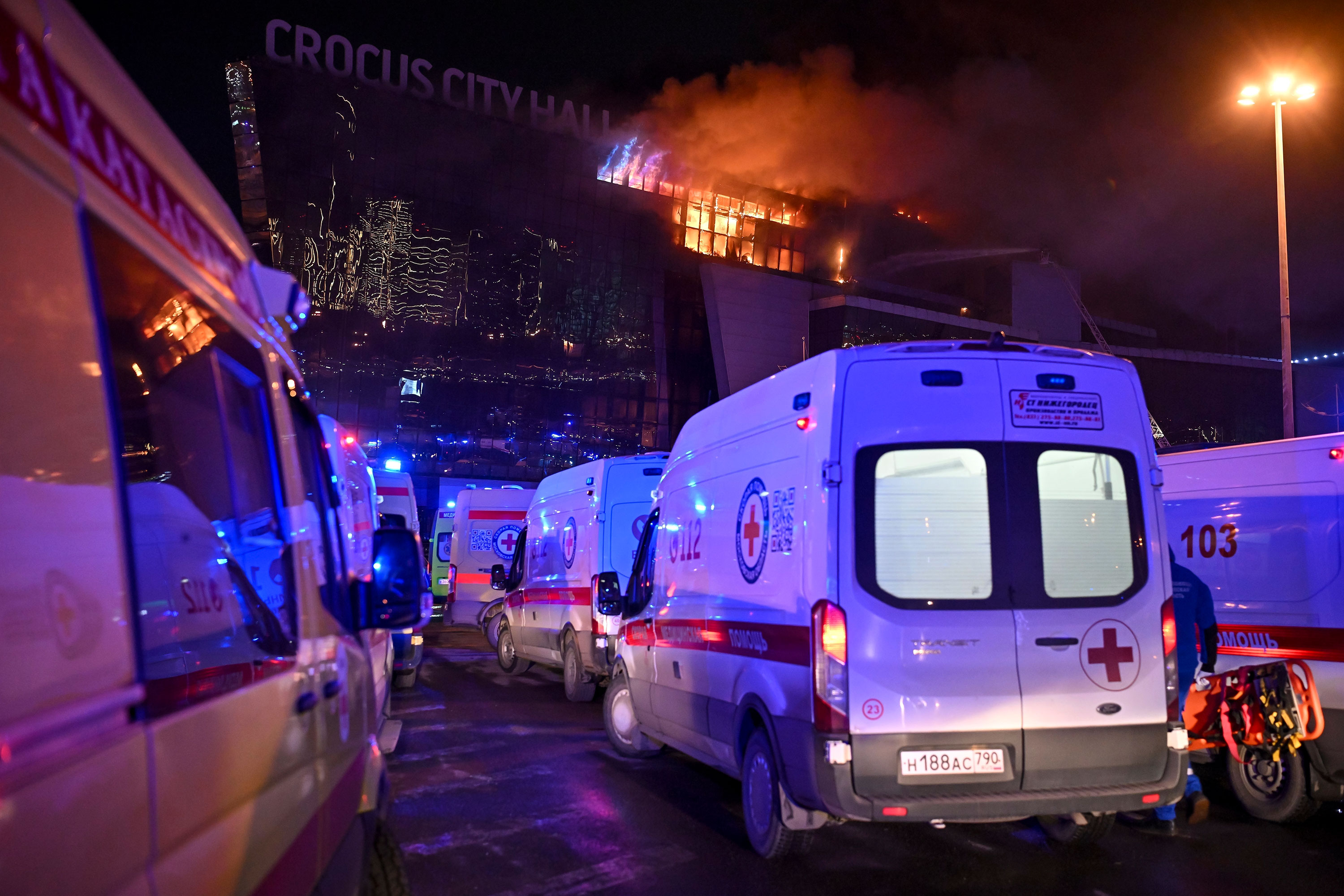 Ambulances park near a burning building of the Crocus City Hall on the western edge of Moscow on Friday. 