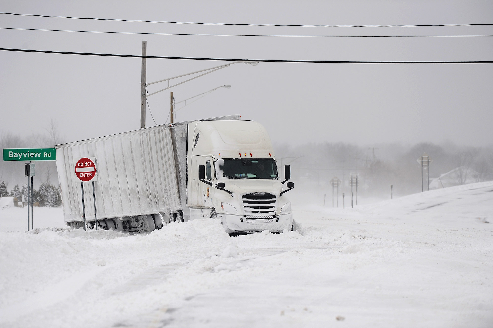 A truck remains stuck in snow in Hamburg in Erie County, New York. 