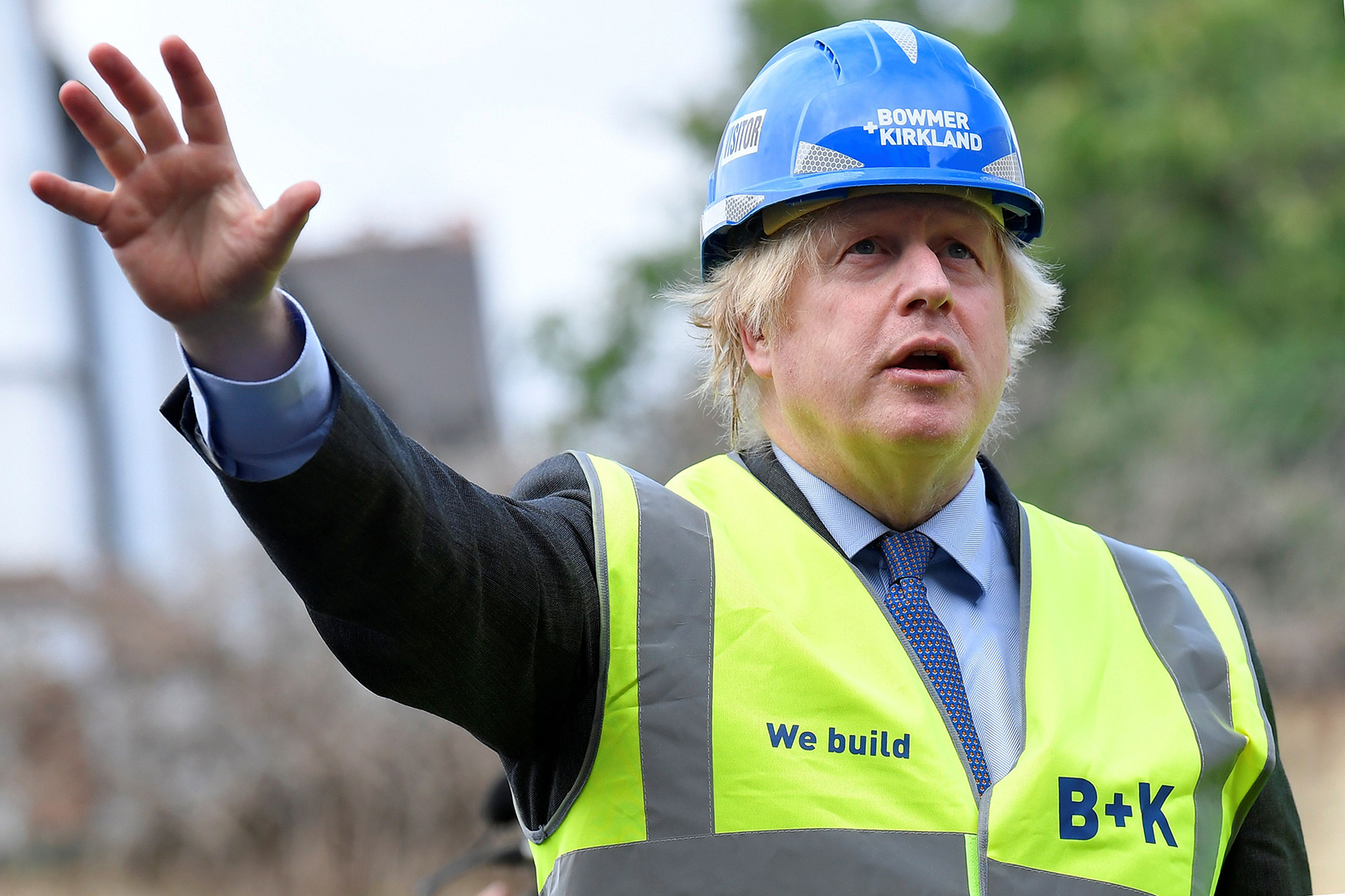 Britain's Prime Minister Boris Johnson gestures as he visits the construction site of Ealing Fields High School on June 29 in London.