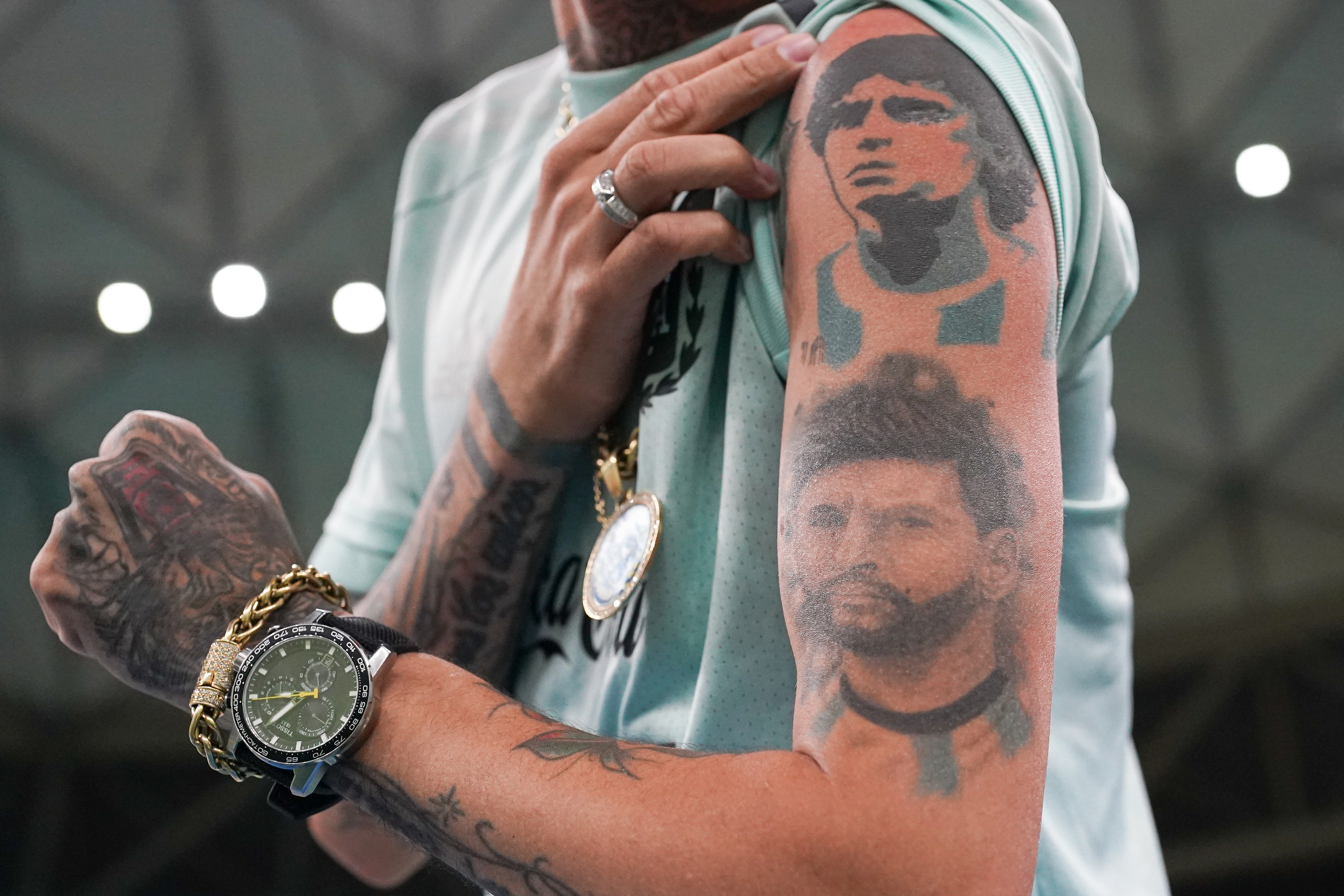 An Argentine fan shows off his Lionel Messi and Diego Maradona tattoos before the match between Argentina and Mexico at the Khalifa International Stadium in Doha, Qatar, Nov. 26.